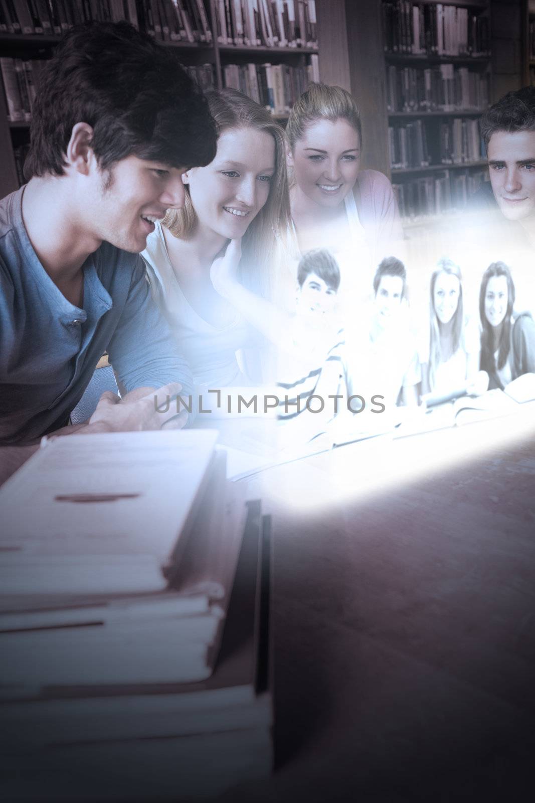 Cheerful college friends watching photos on futuristic interface in university library