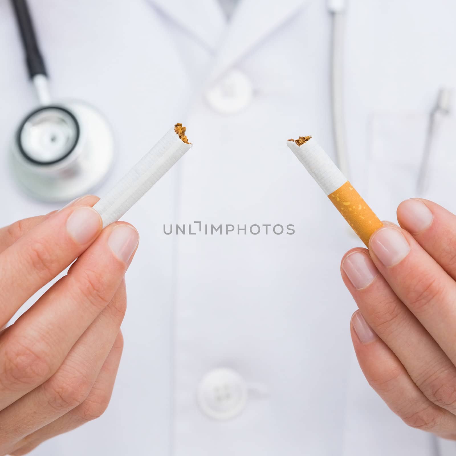 Close up on doctor breaking cigarette by Wavebreakmedia
