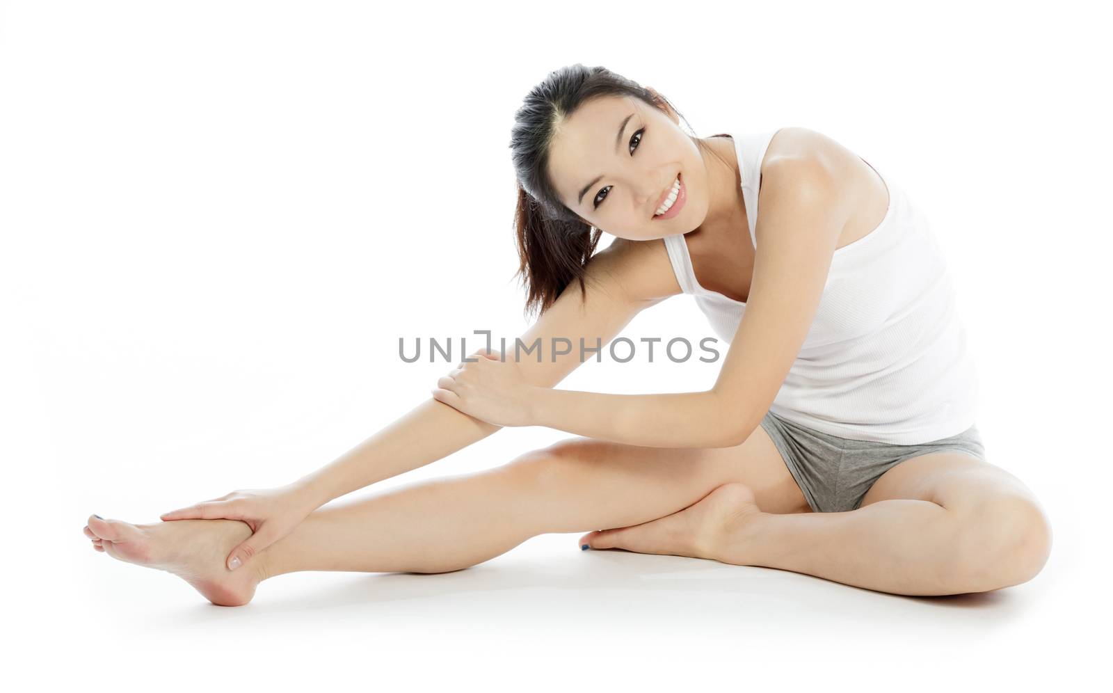 Attractive asian girl in her twenties isolated on a plein background shot in a studio