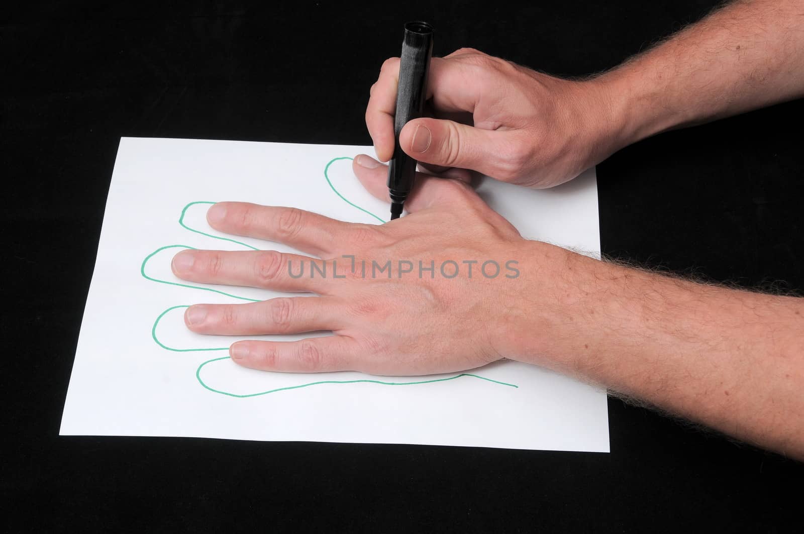 A Caucasian Male Hand Drawing on a White Paper