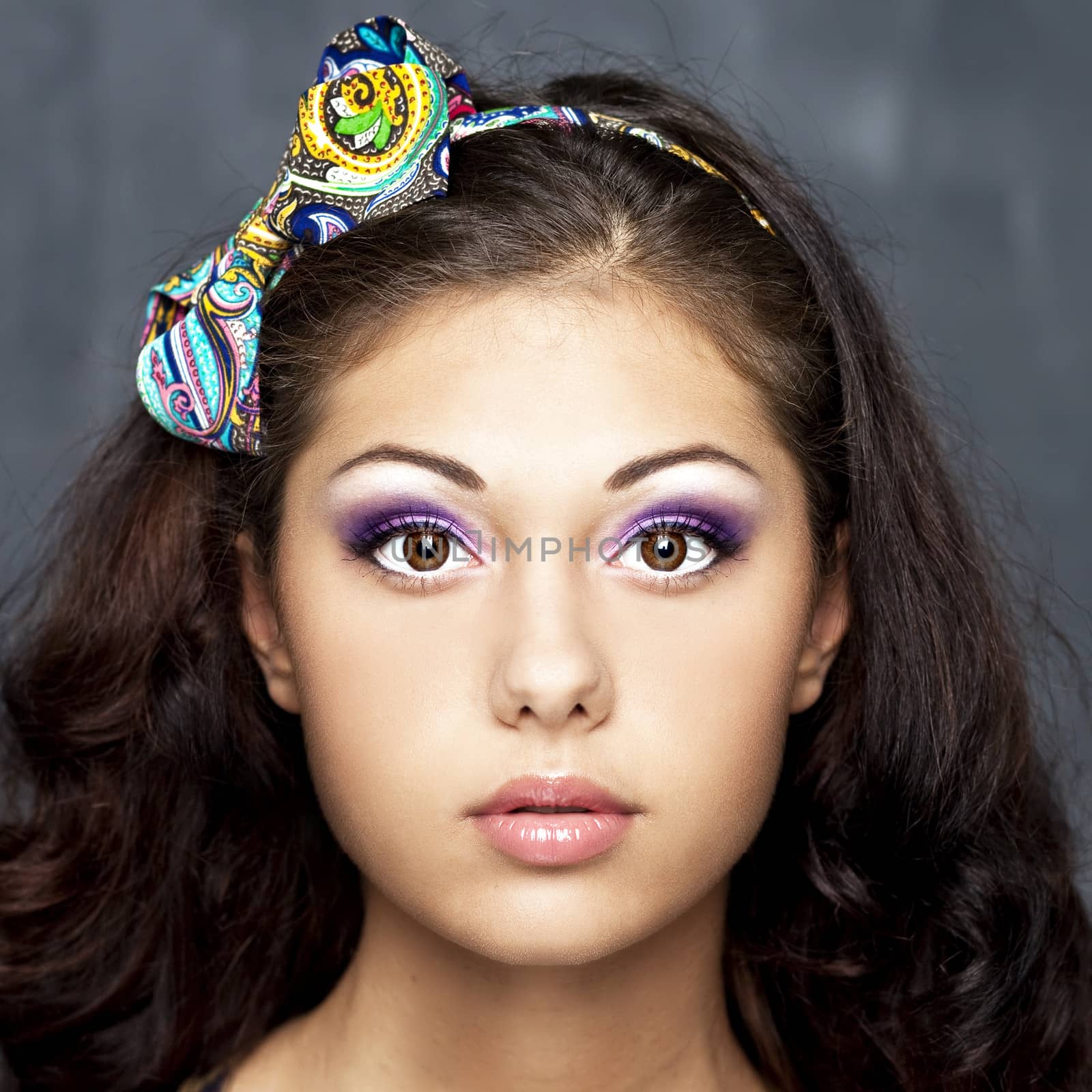 Portrait of a young woman with a rim on the head