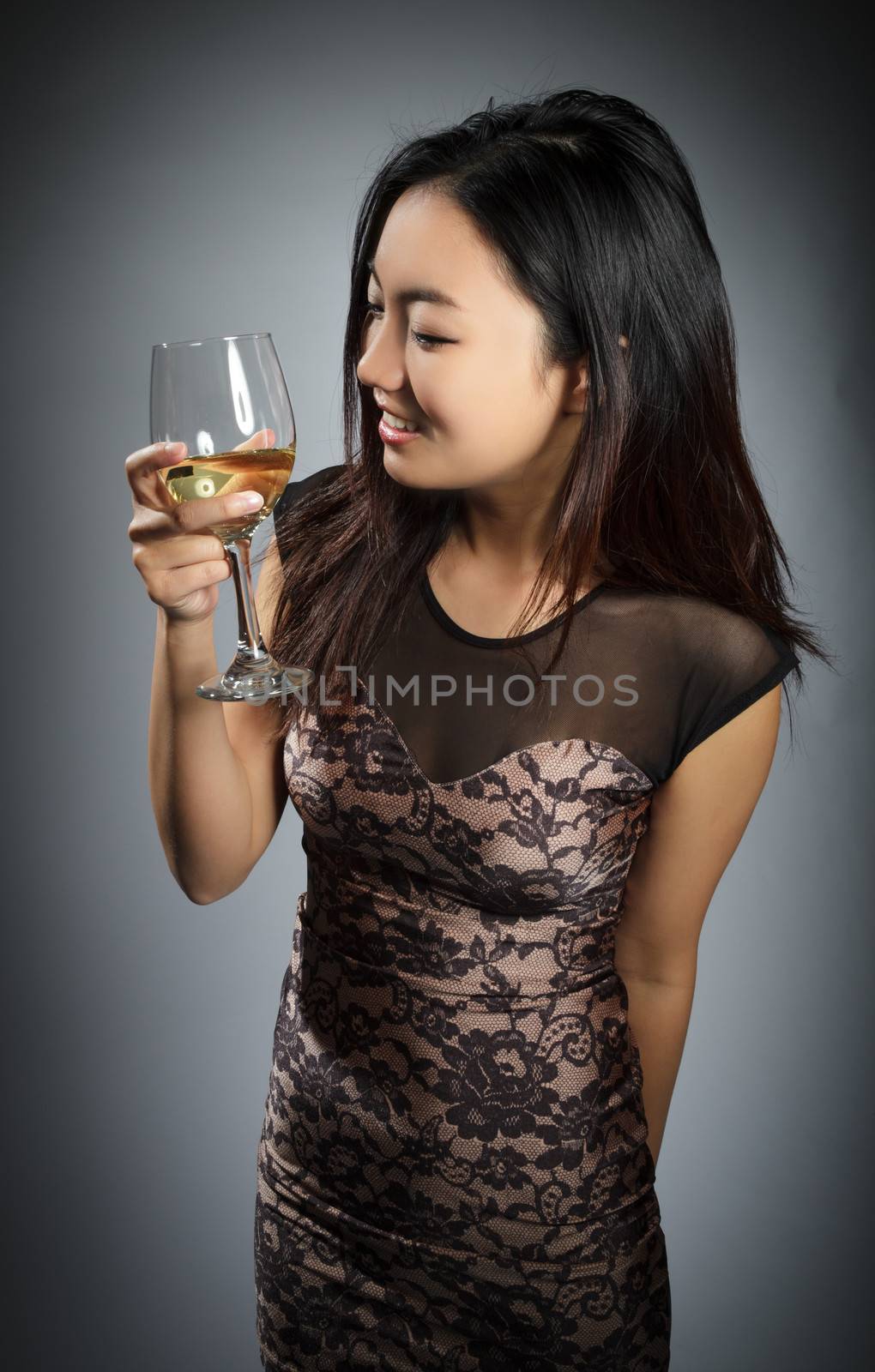 Attractive asian girl in her twenties isolated on a plein background shot in a studio