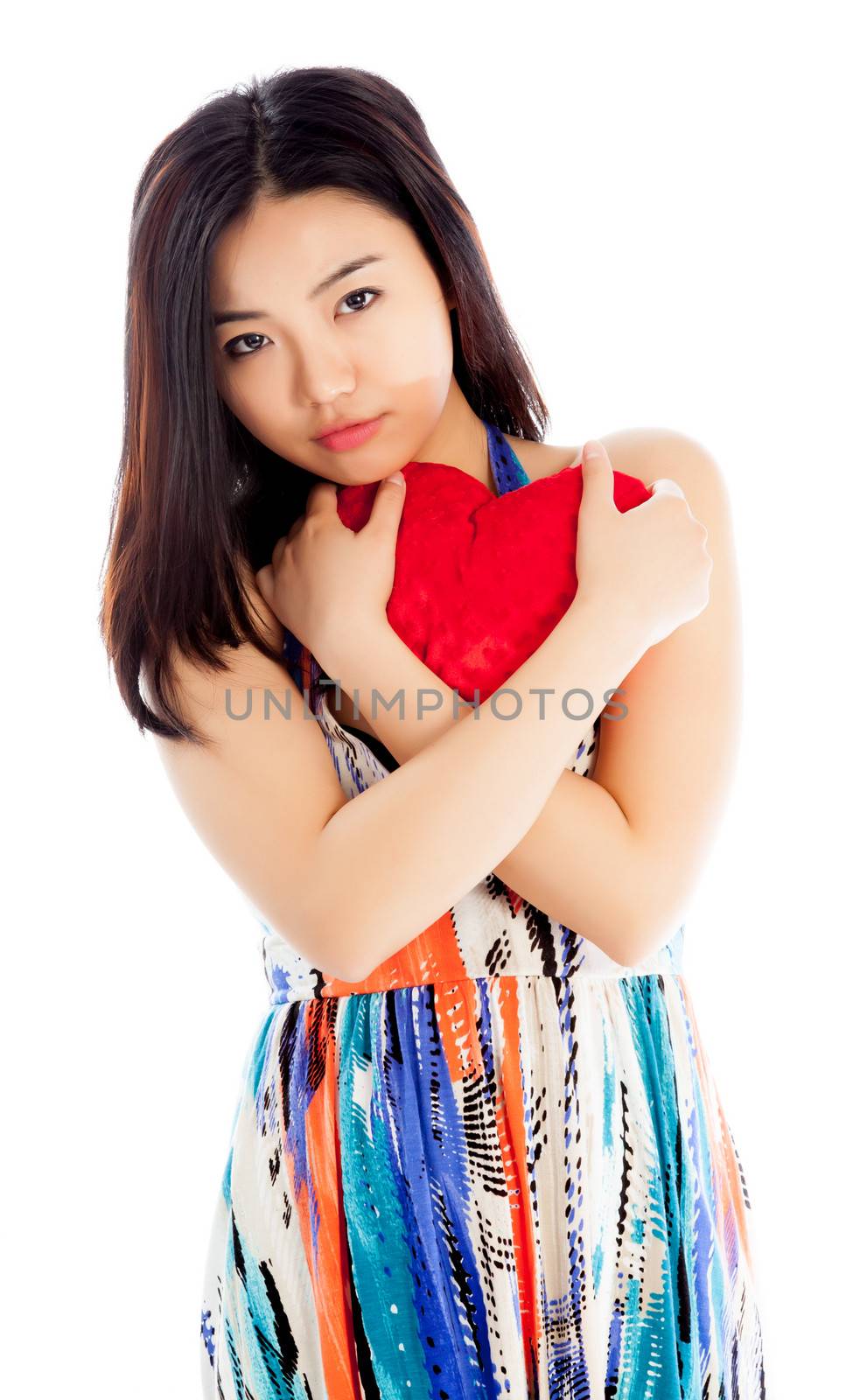 Attractive asian girl in her twenties isolated on a plein background shot in a studio