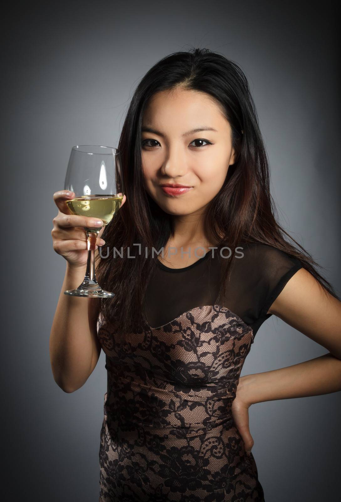 Attractive asian girl in her twenties isolated on a plein background shot in a studio