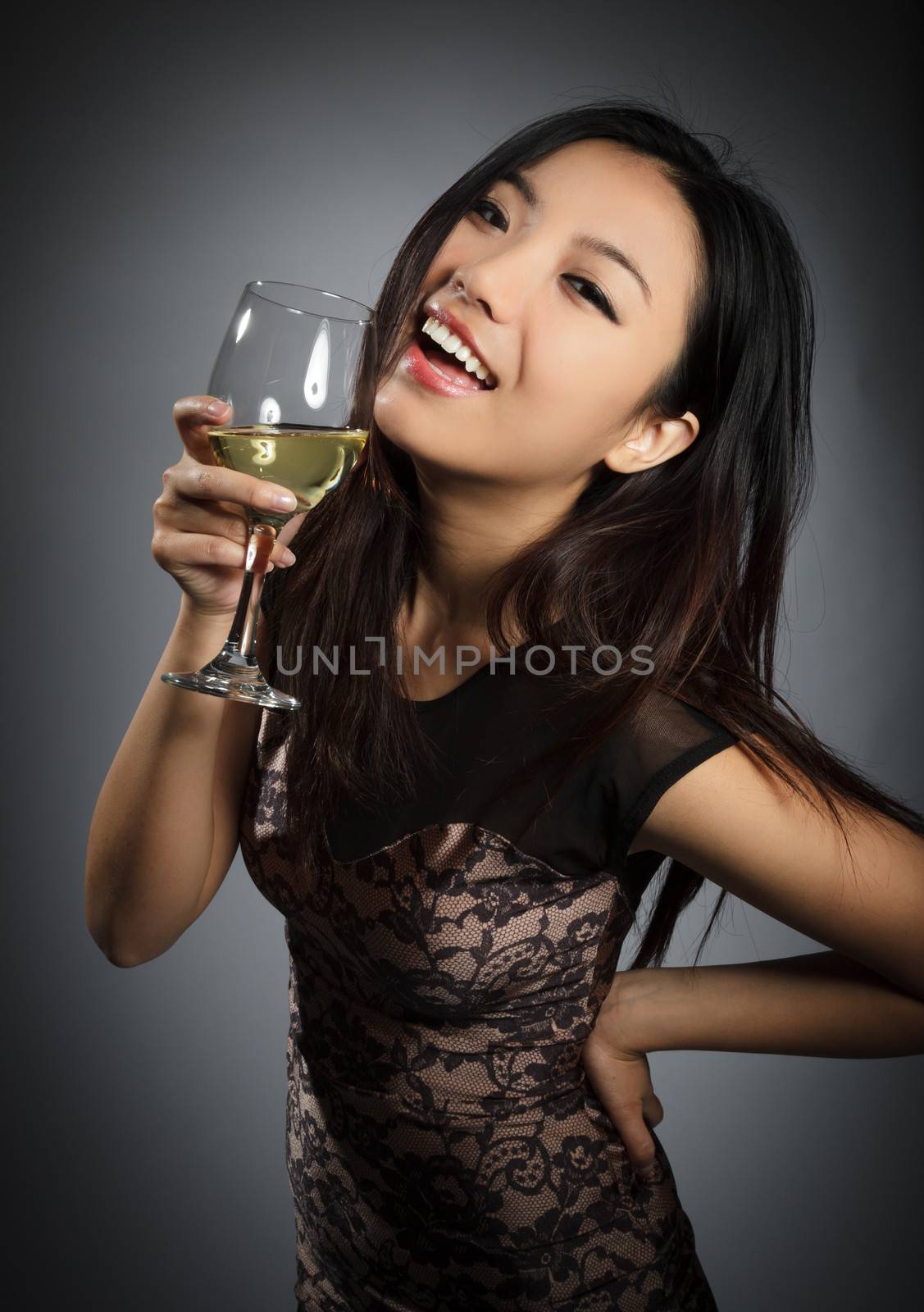 Attractive asian girl in her twenties isolated on a plein background shot in a studio