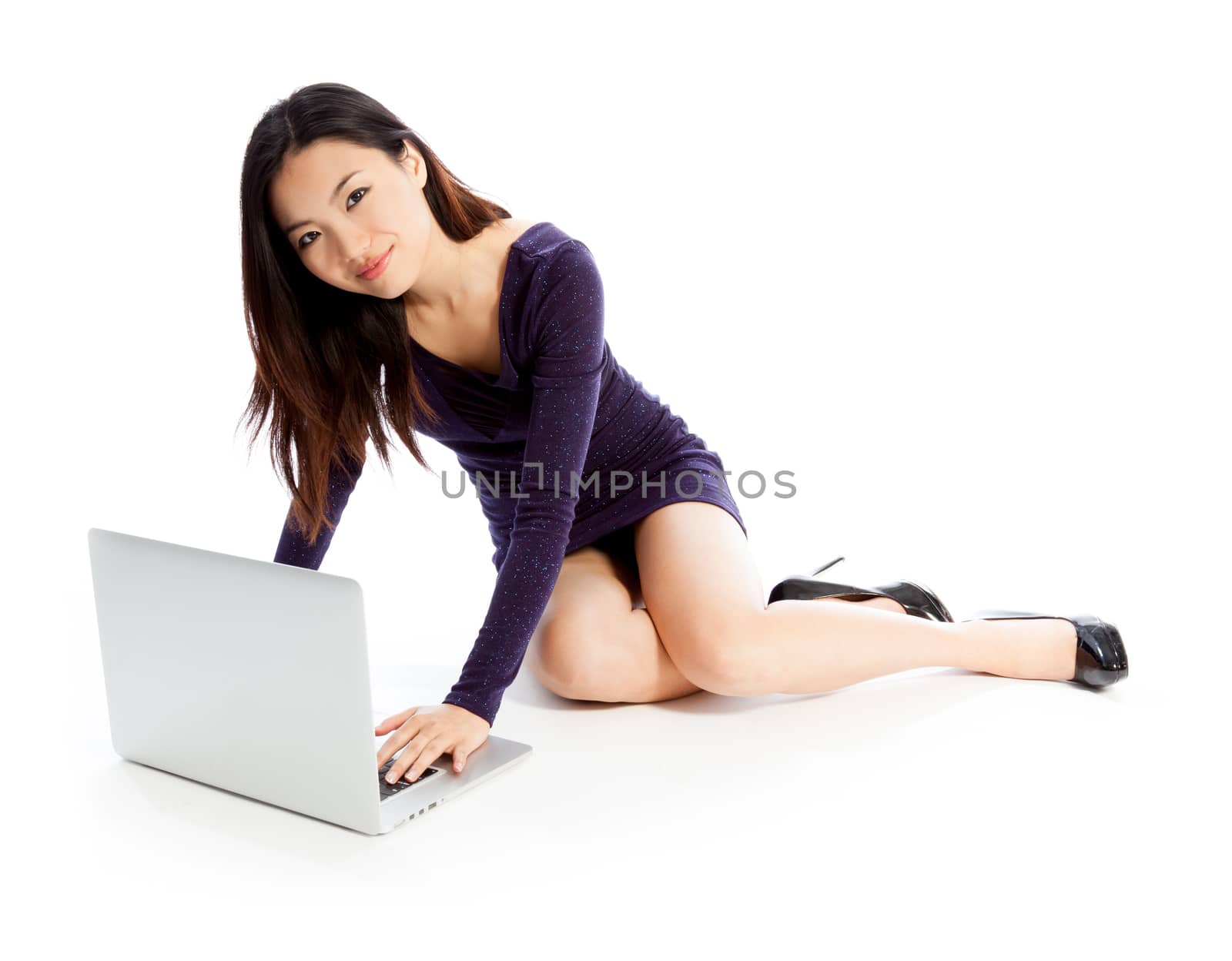 Attractive asian girl in her twenties isolated on a plein background shot in a studio