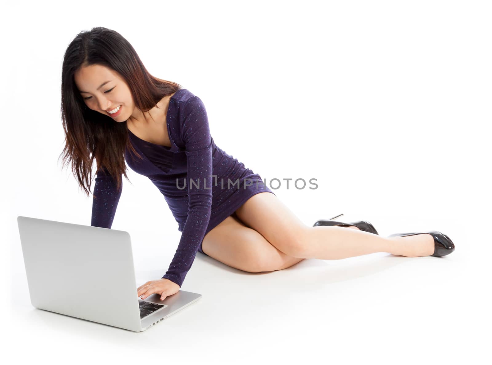 Attractive asian girl in her twenties isolated on a plein background shot in a studio