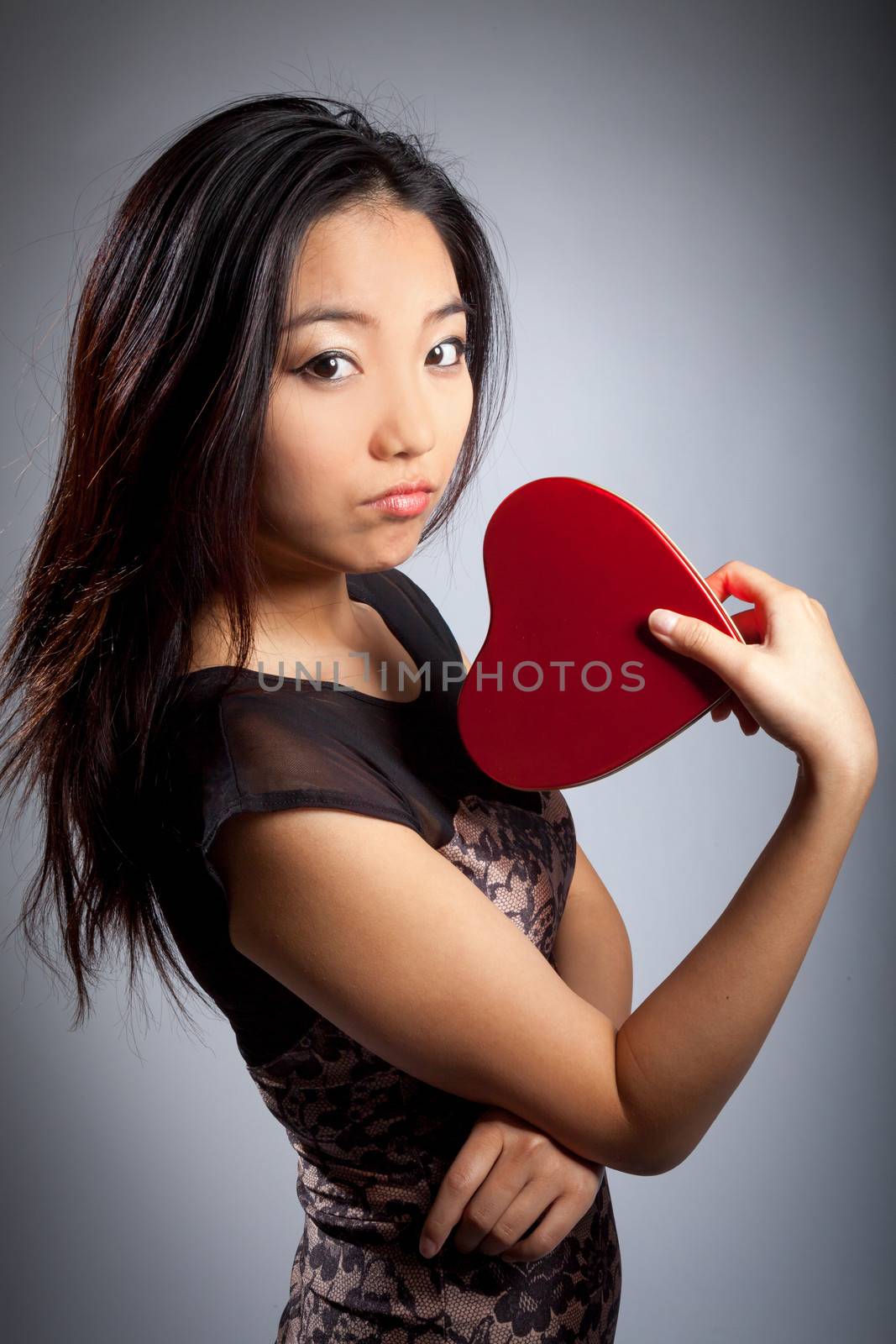 Romantic people in love shot in studio isolated on a grey background