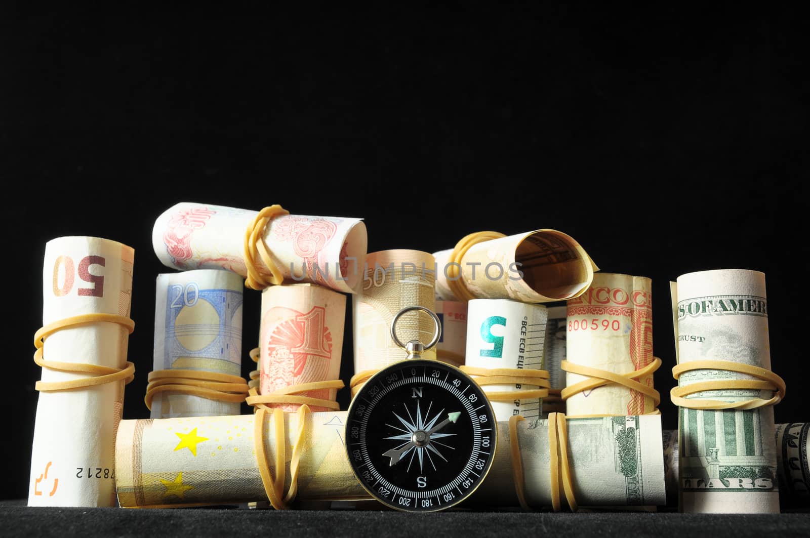 Orientation in  Business Compass and Money on a Black Background