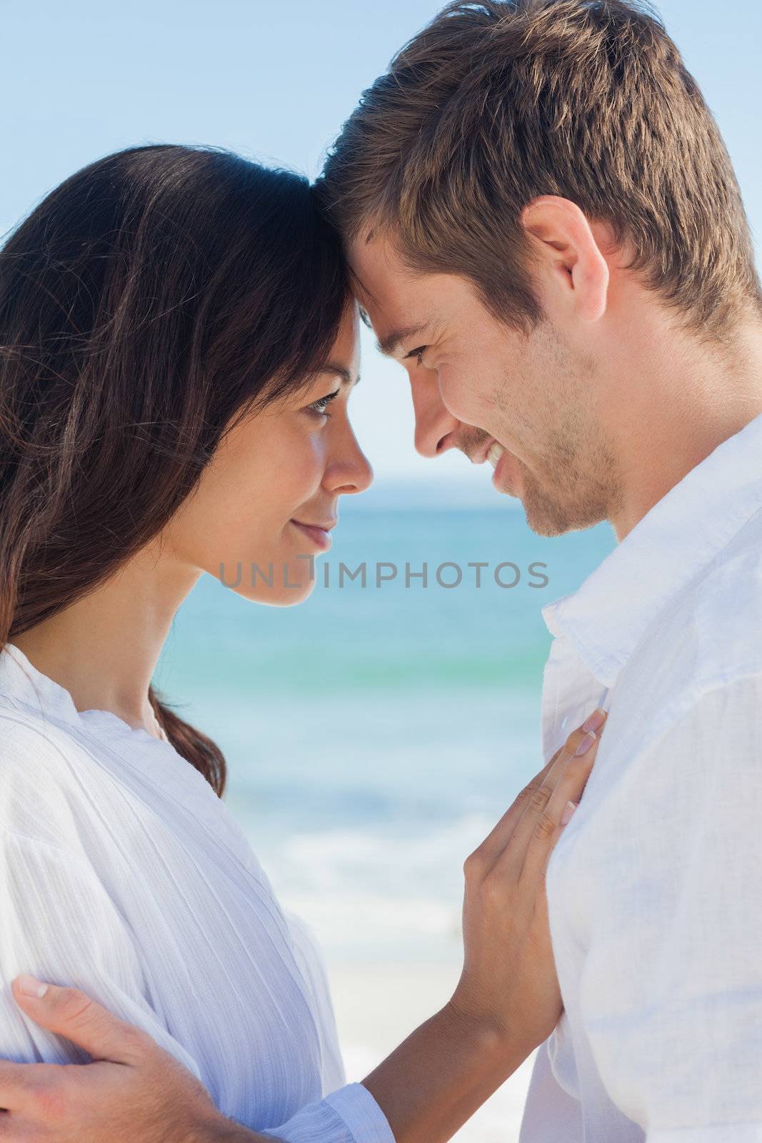 Romantic couple relaxing and embracing on the beach