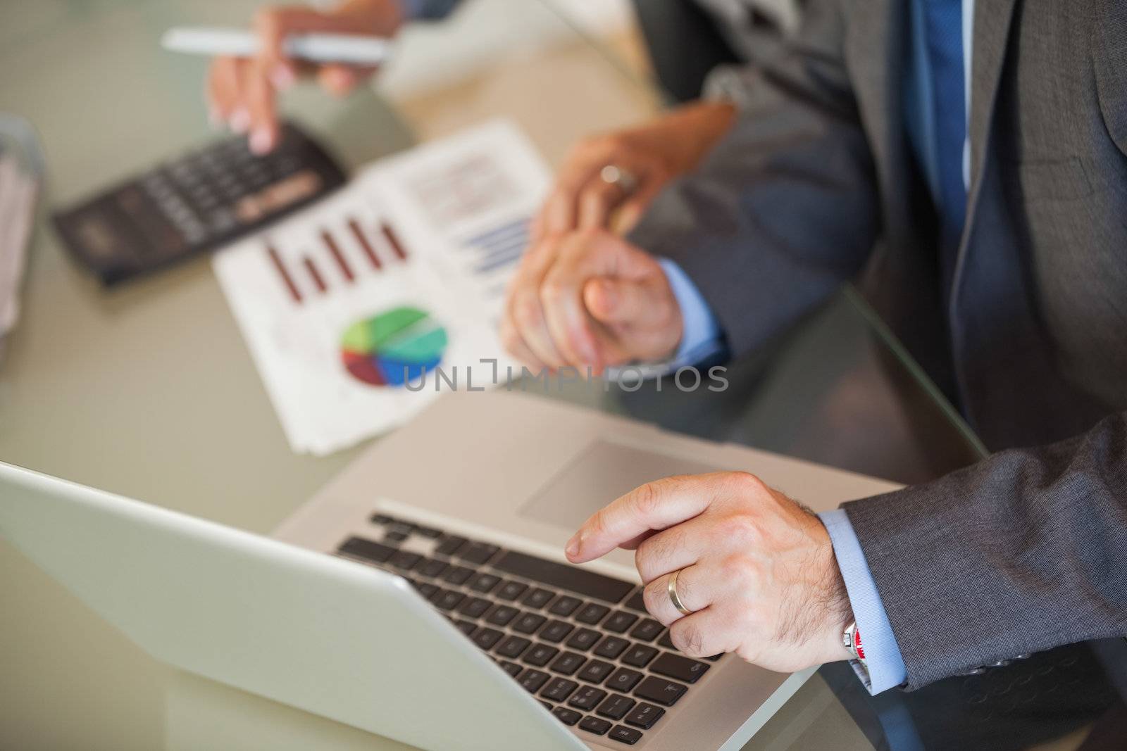 People in an office looking a laptop by Wavebreakmedia