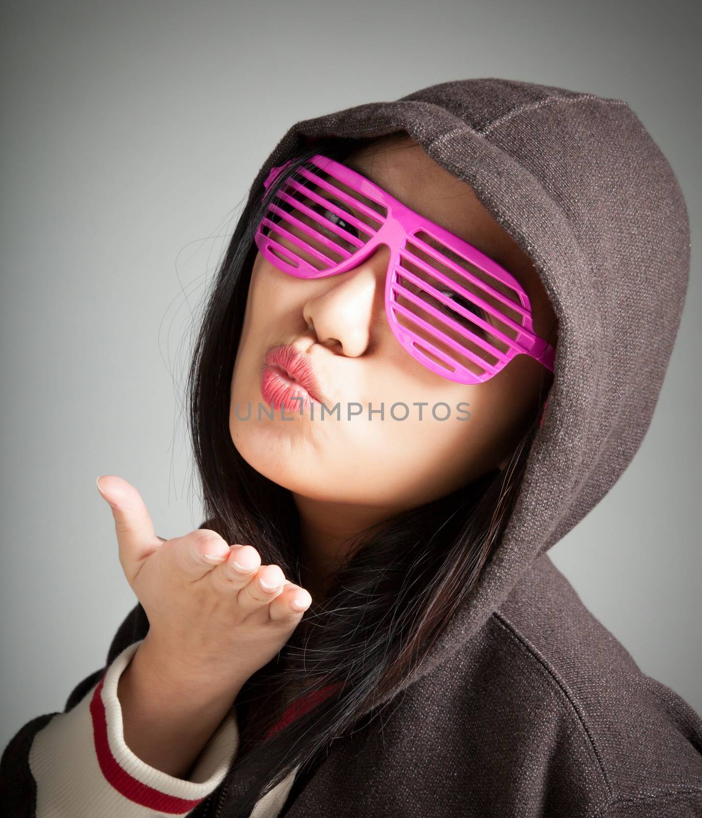 Attractive asian girl in her twenties isolated on a plein background shot in a studio