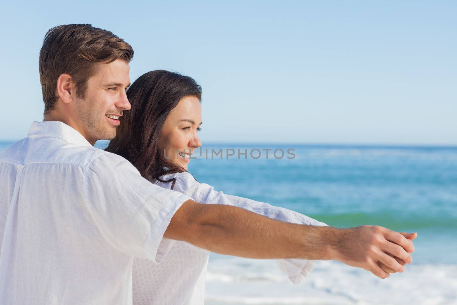 Romantic couple relaxing on the beach during the summer