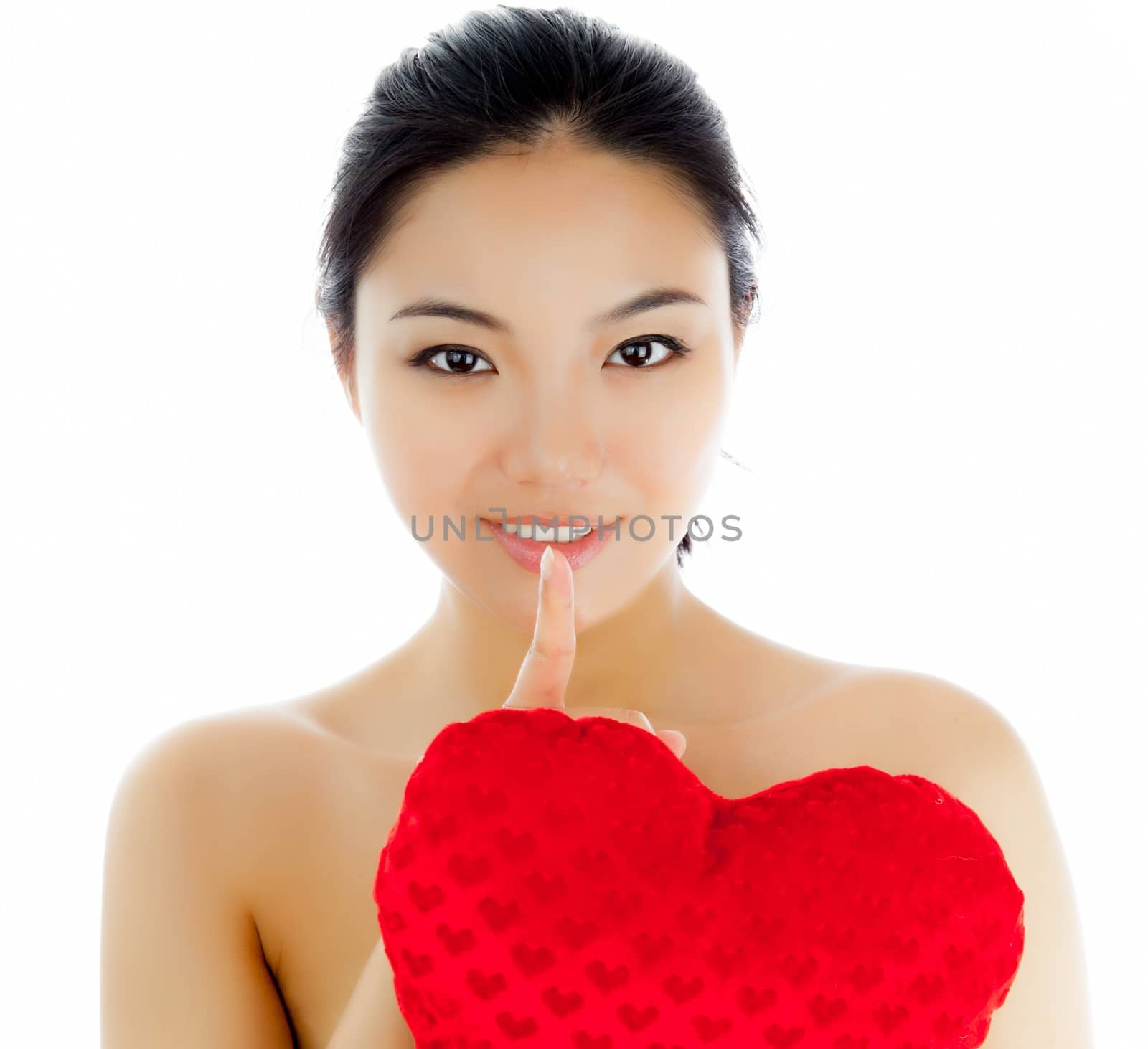 Attractive asian girl in her twenties isolated on a plein background shot in a studio