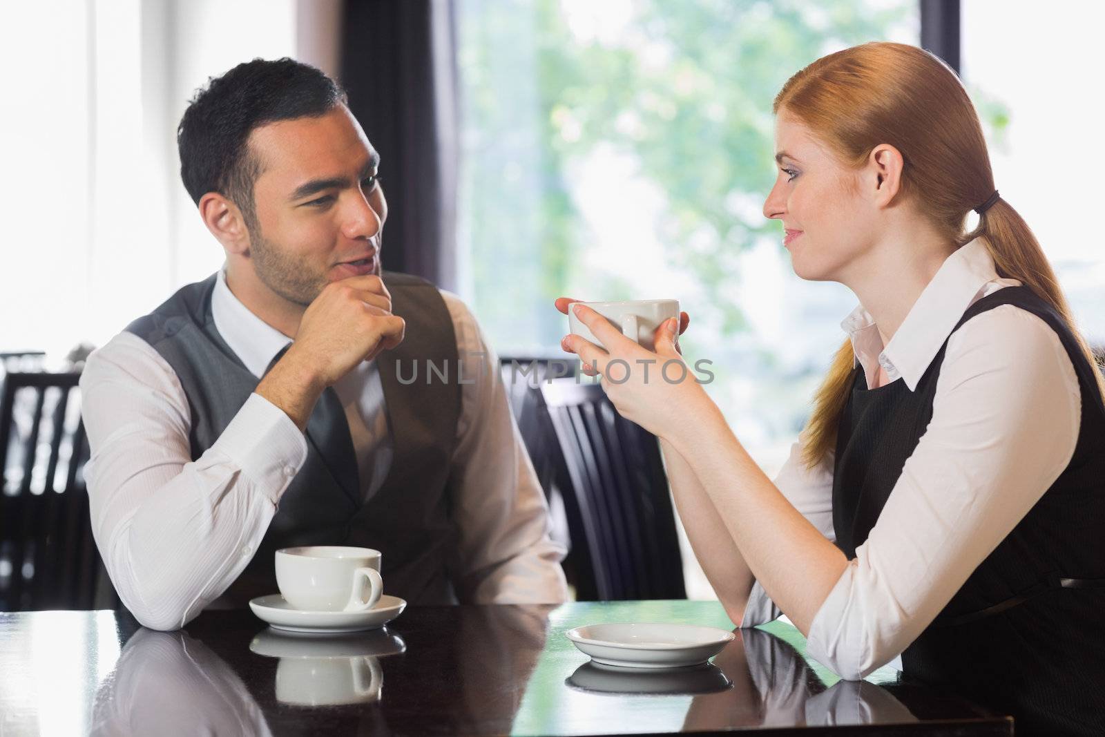 Business people talking over coffee in a cafe