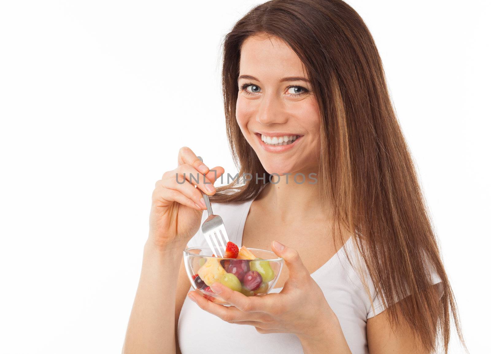 Pretty woman eating fruits with a fork, isolated on white