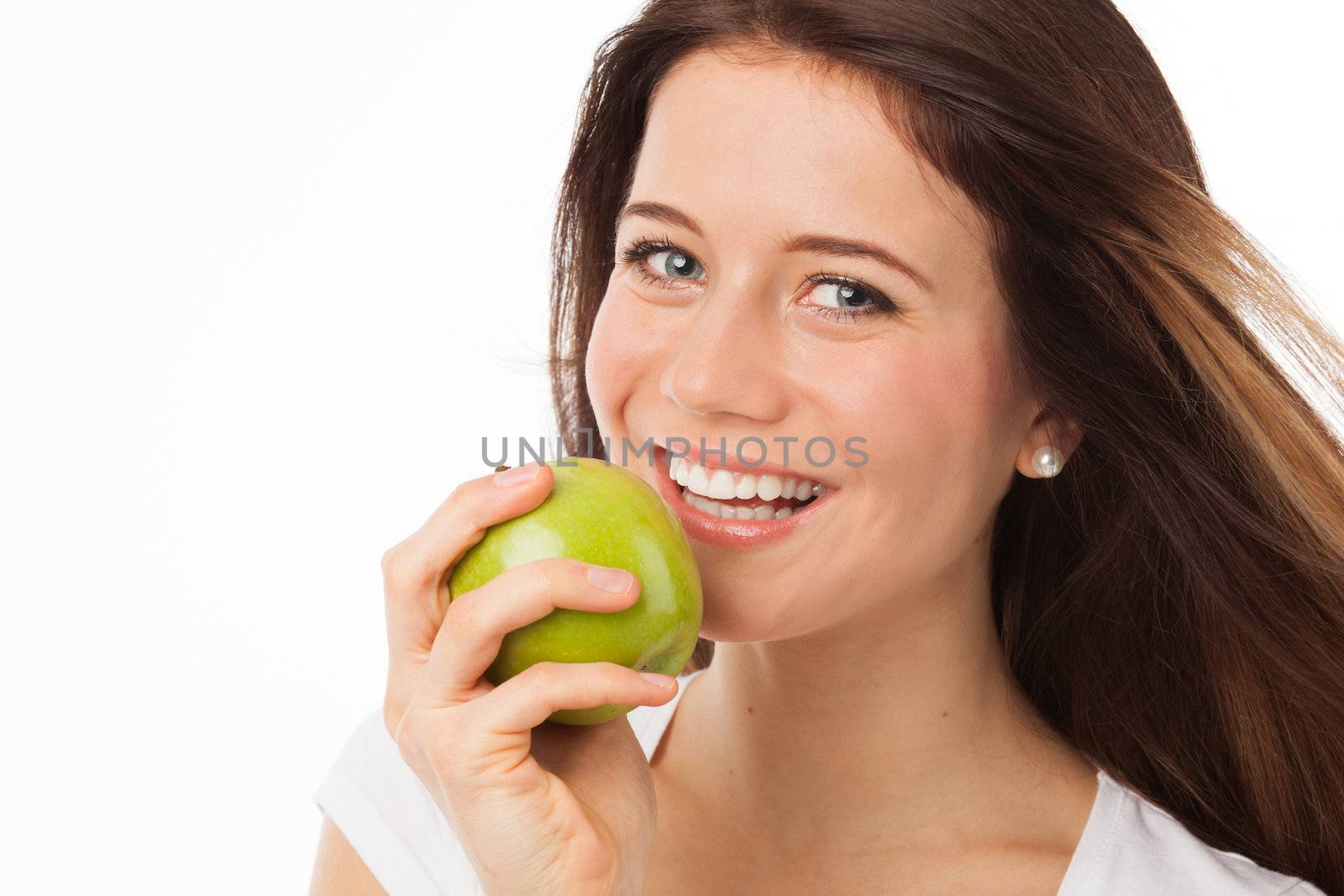 Close up portrait of a beautiful woman eating a green apple, isolated on white
