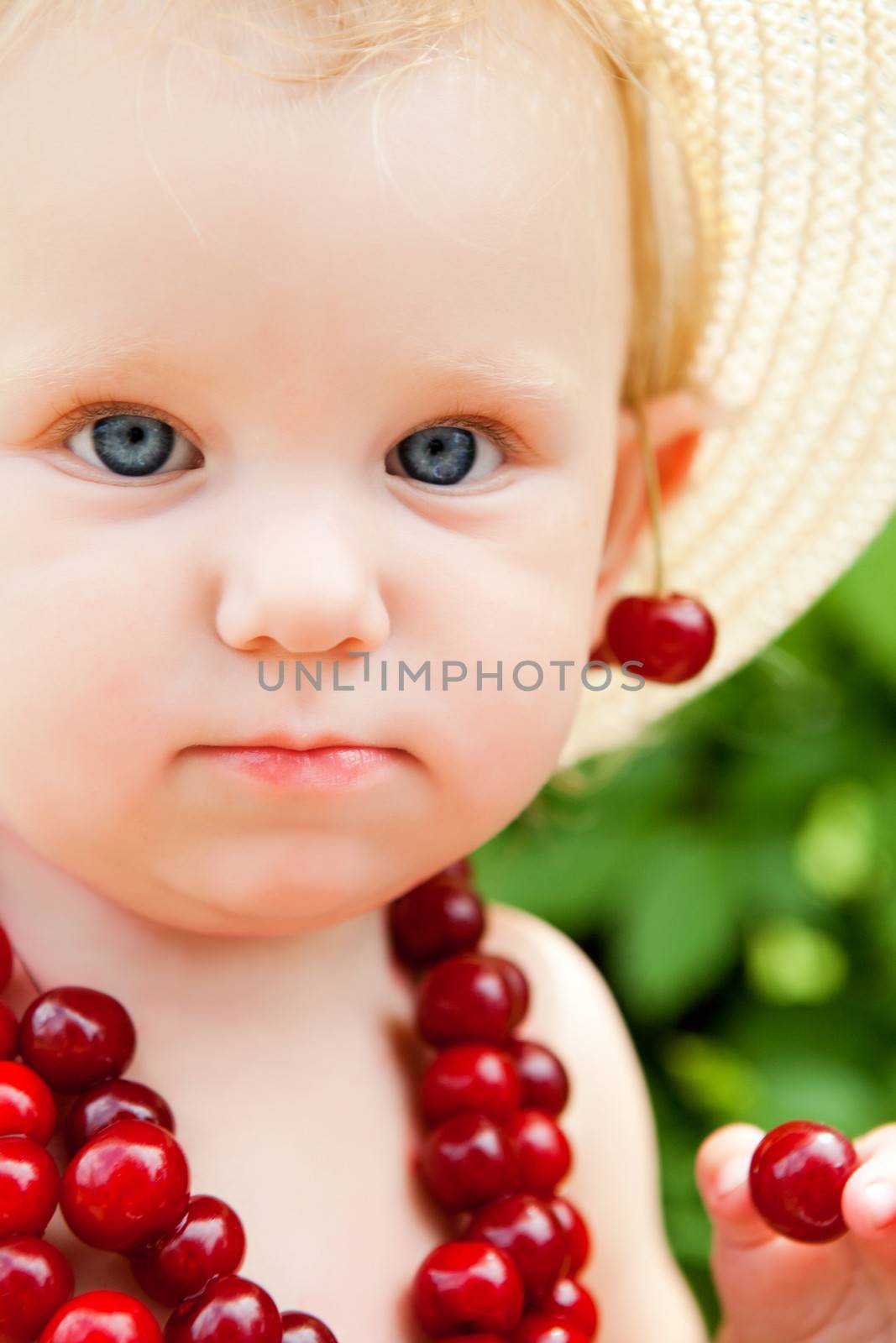 portrait od the child with cherry beads