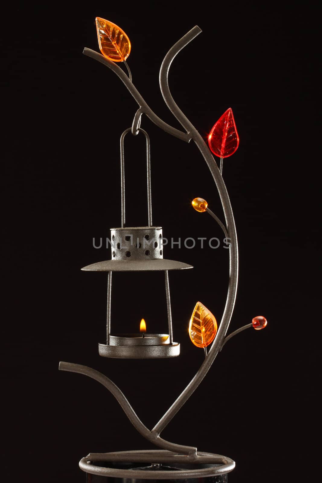 candle holder with glass decorations over black