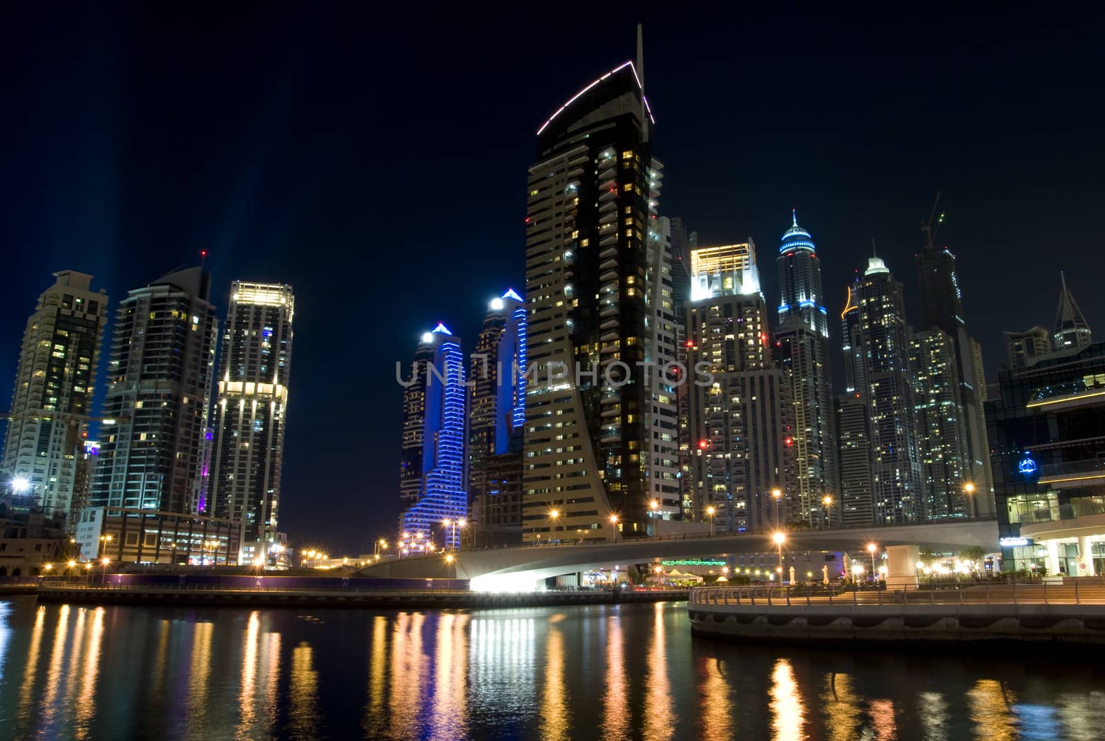 Bright lights Dubai marina scene at night