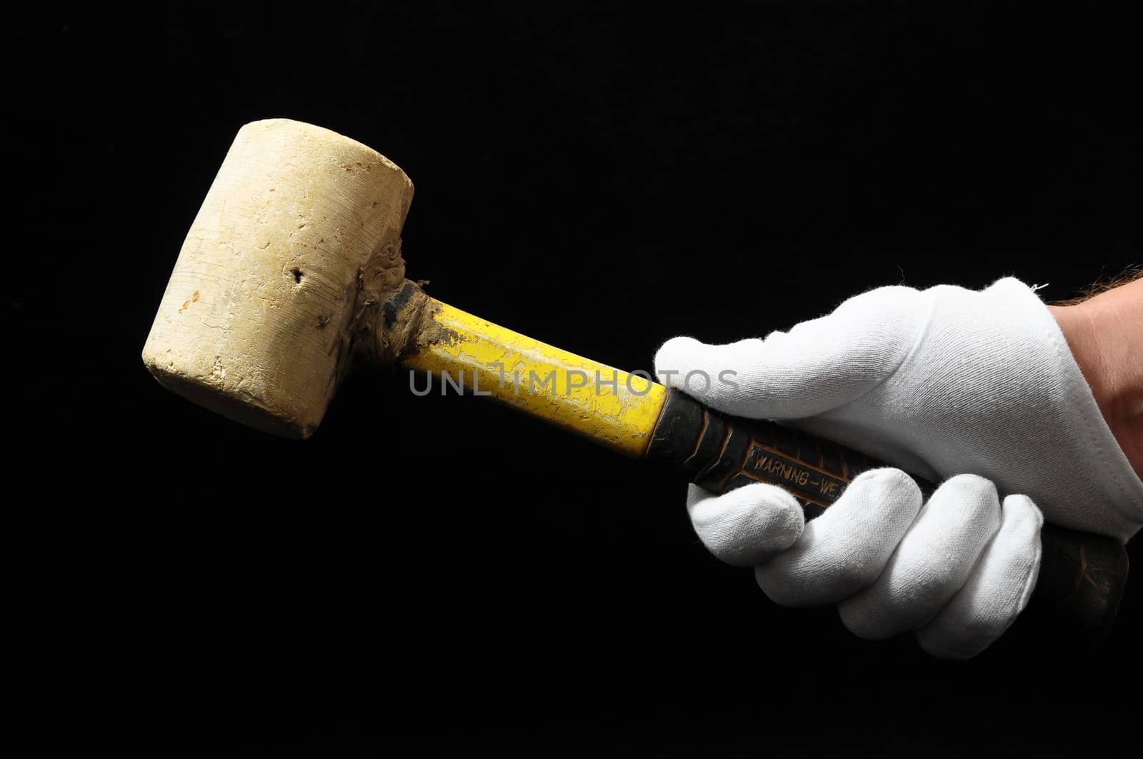 Hammer and a Hand on a Black Background