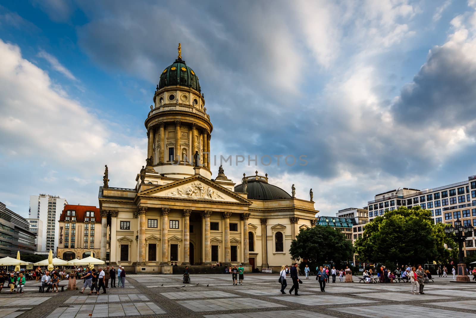 BERLIN, GERMANY - AUGUST 10: German Cathedral and Gendarmenmarkt Square on August 10, 2013 in Berlin, Germany. The square was created by Johann Arnold Nering at the end of the seventeenth century.
