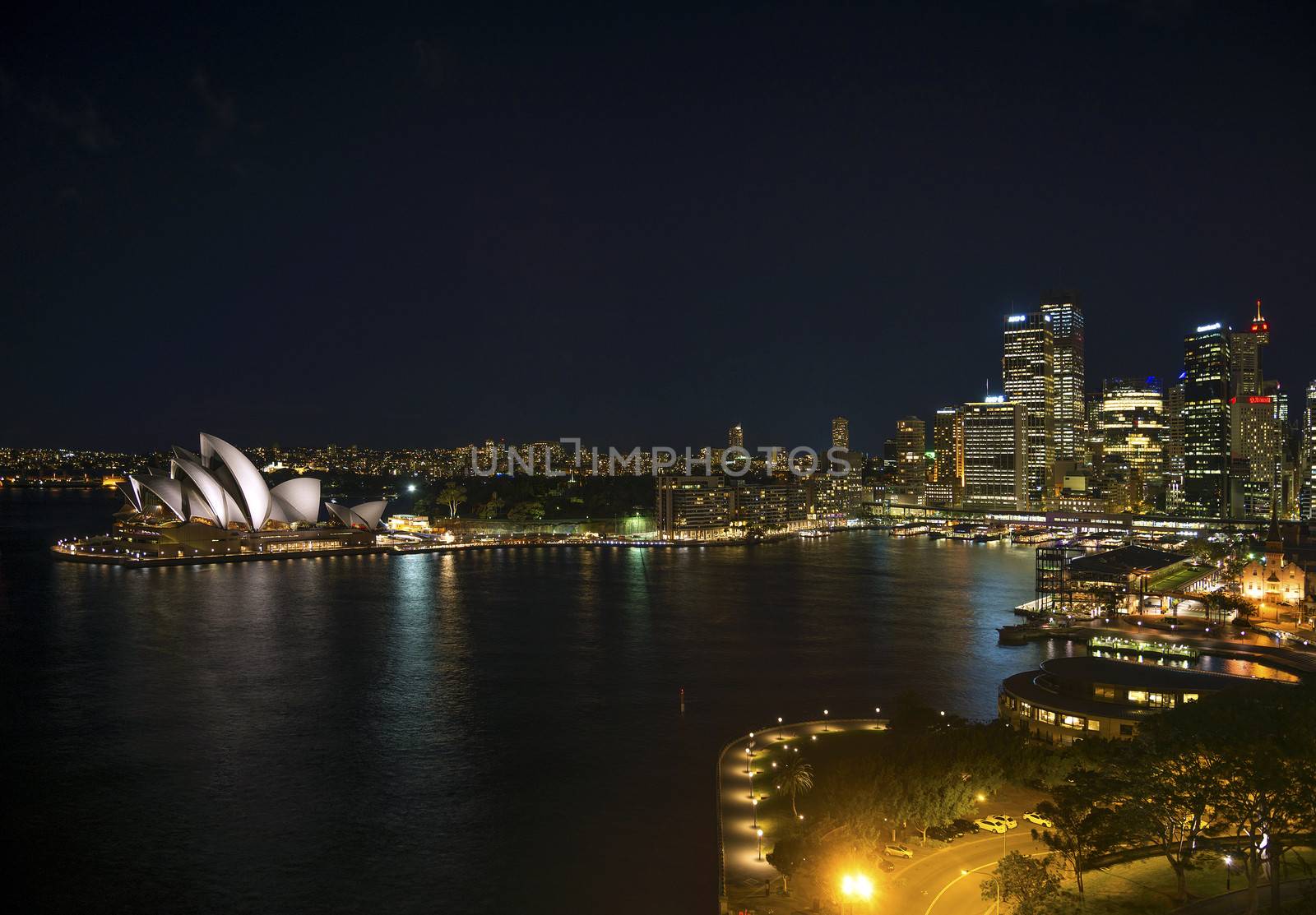 sydney harbour with opera house in australia by night