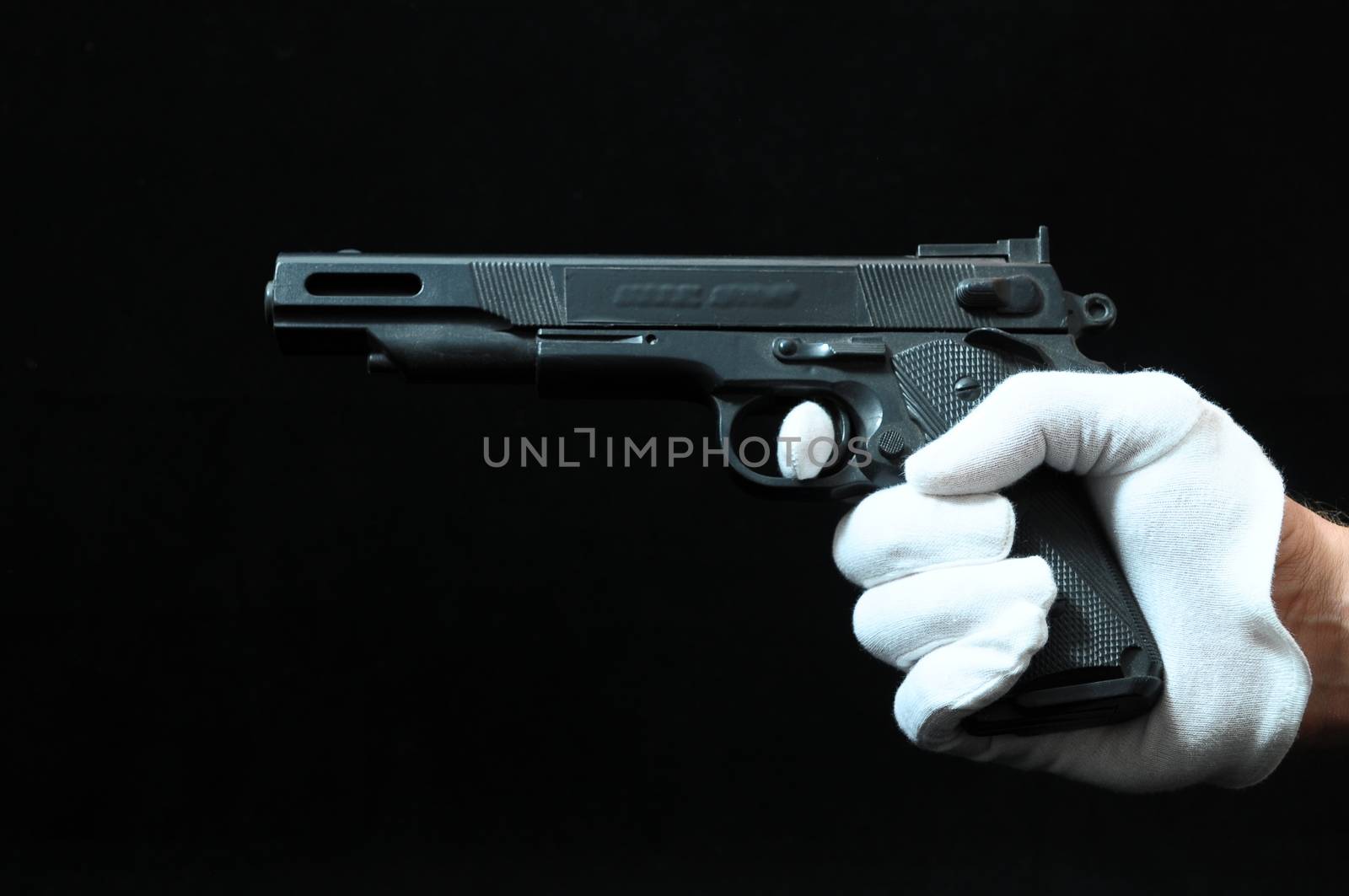 Gun and a Hand on a Black Background by underworld