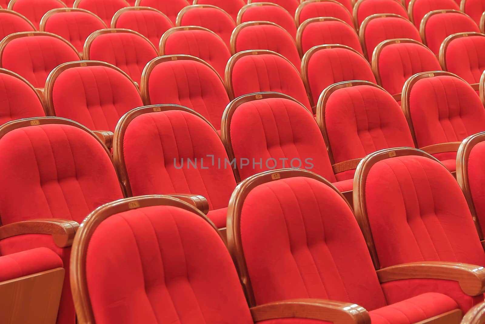 Background of many red theatrical red chairs