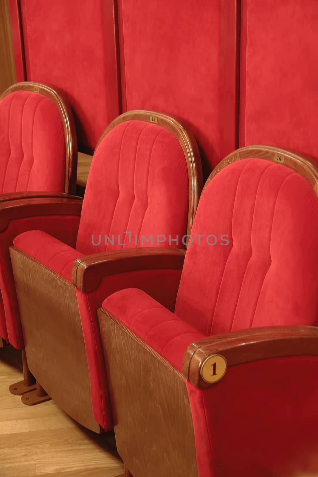 Background of many red theatrical red chairs