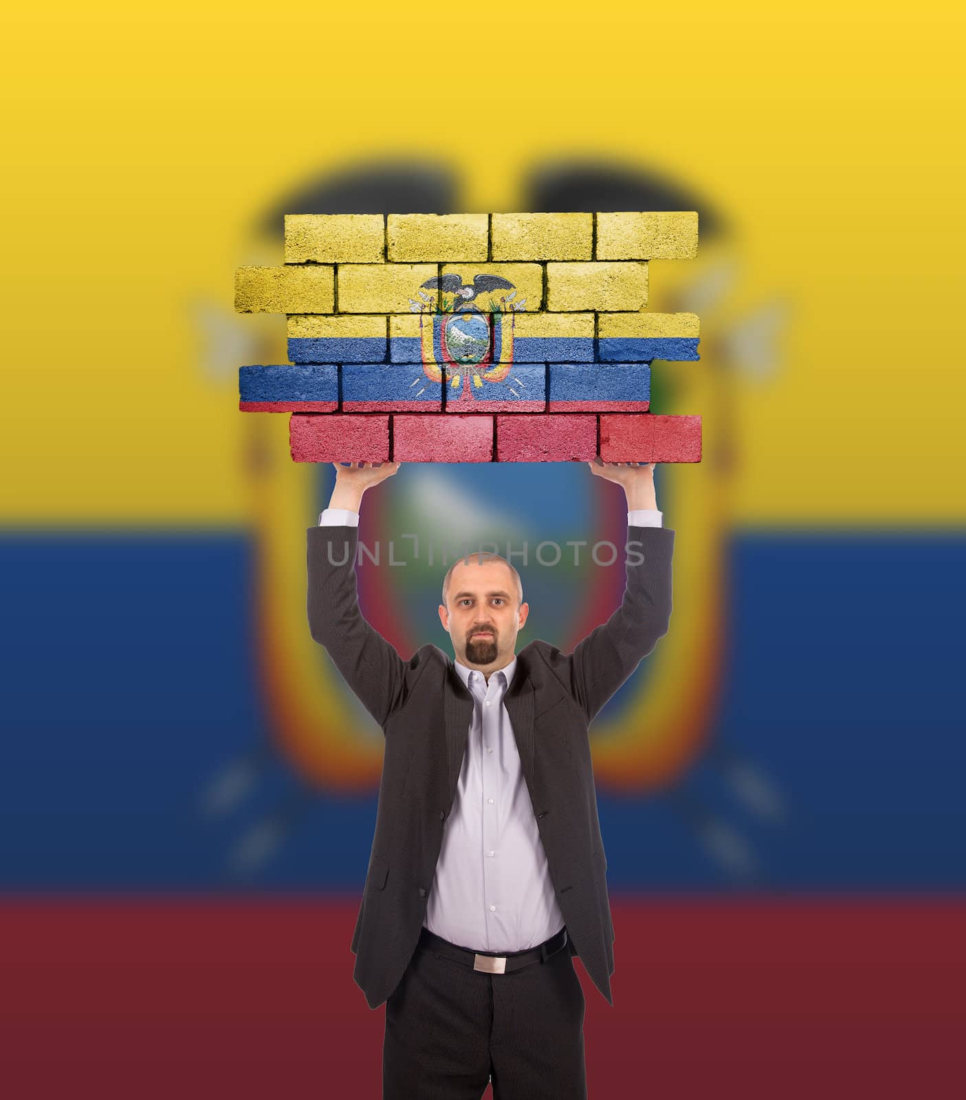 Businessman holding a large piece of a brick wall, flag of Ecuador, isolated on national flag