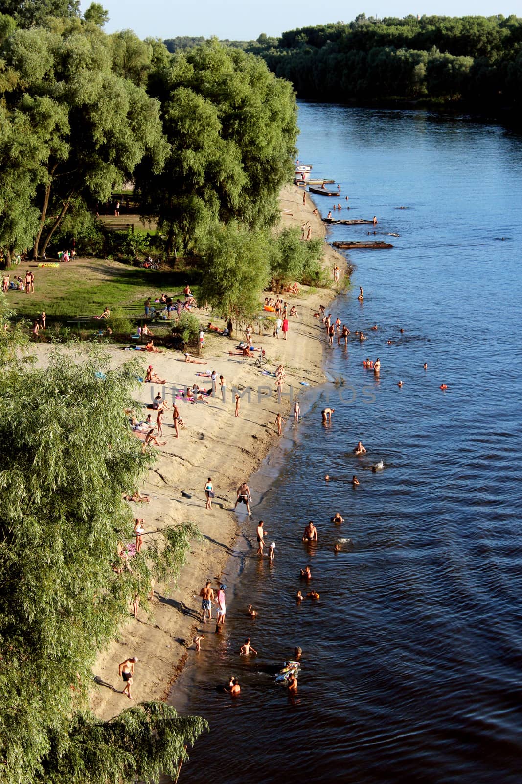 landscape with river beach and swimming people by alexmak