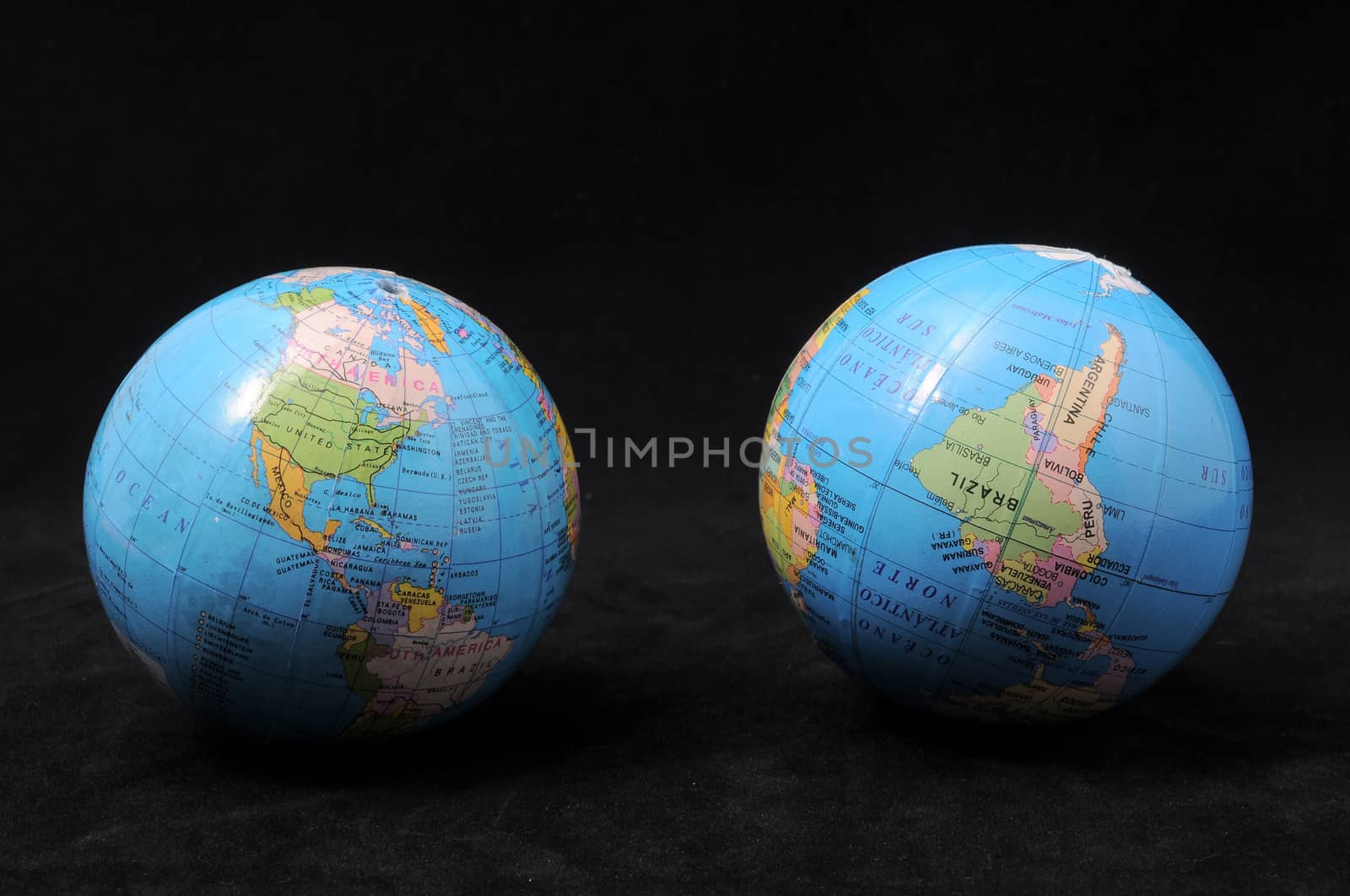 Two Globes on a Dark Background - Time Concept