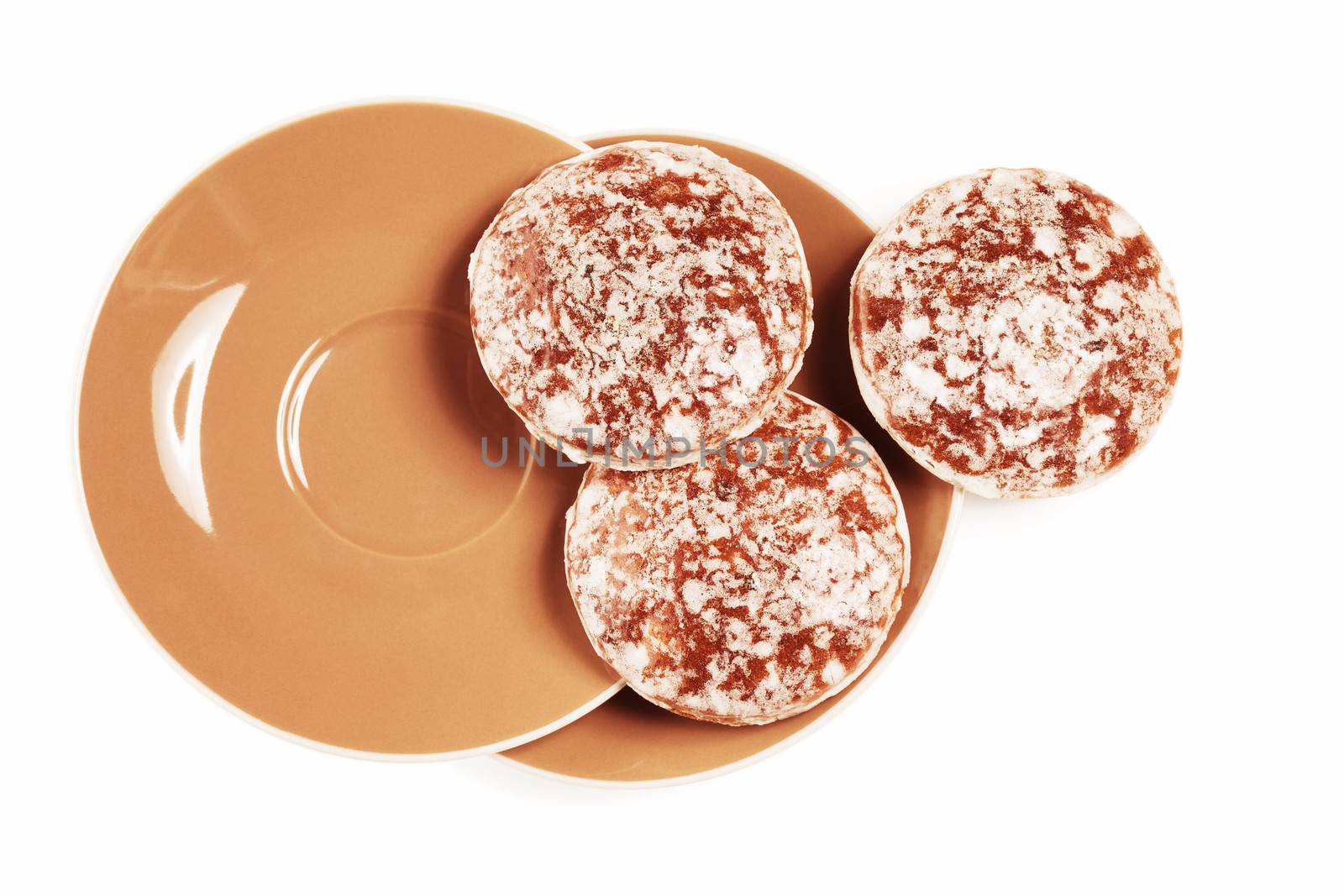 round traditional german christmas lebkuchen gingerbread cookies from top with small brown plates on white background
