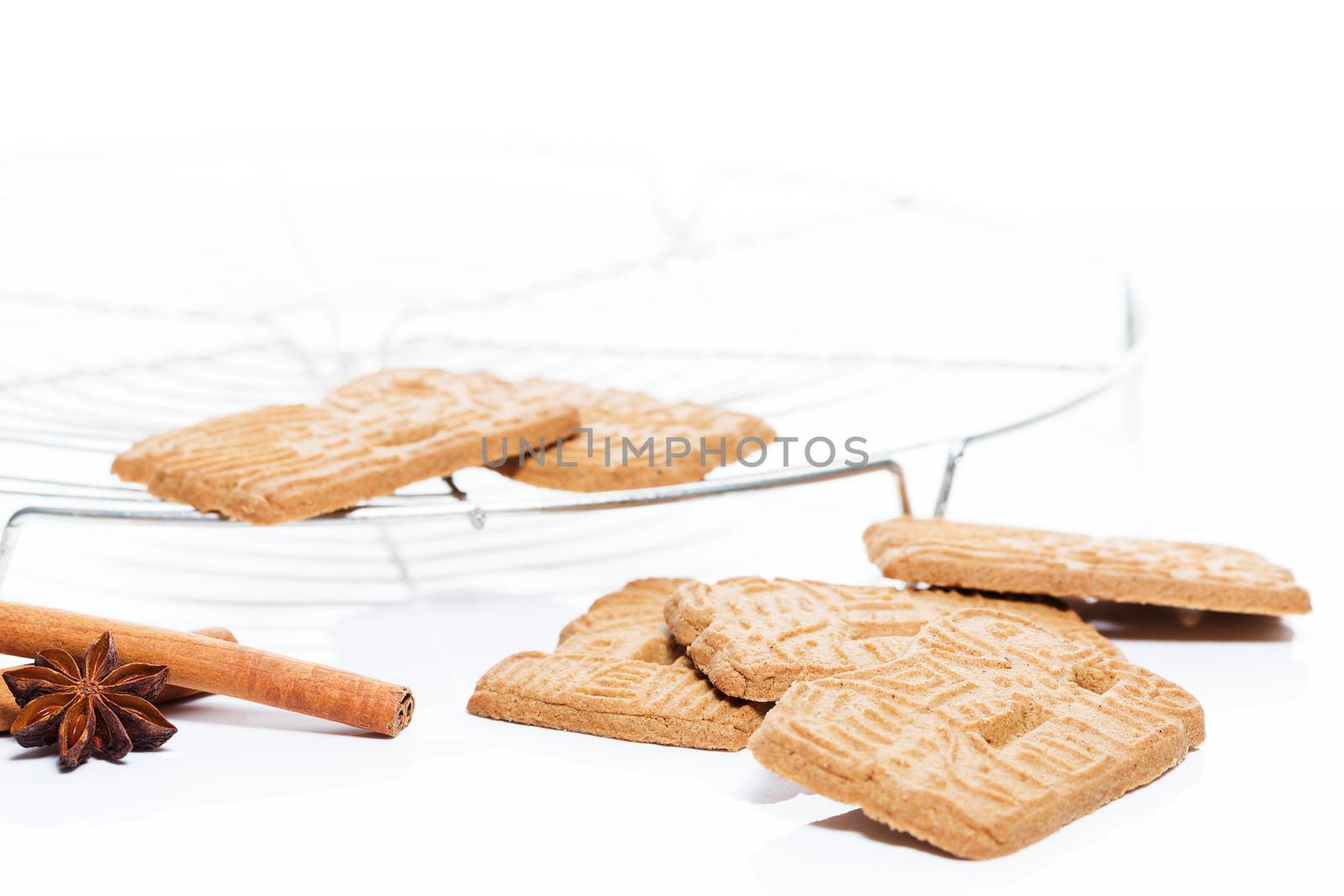 traditional spicy almond spekulatius christmas cookies with a cooling grid cinnamon and aniseed