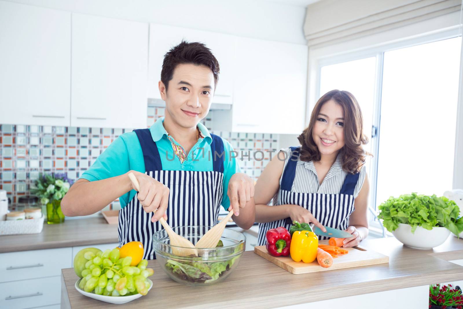 Young happy couples in domestic kitchen