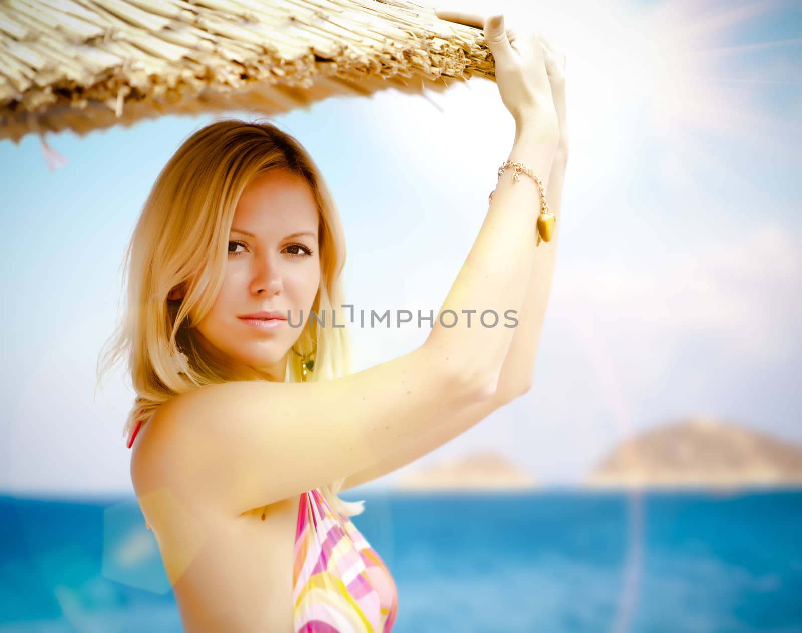 Portrait of young pretty woman on a beach