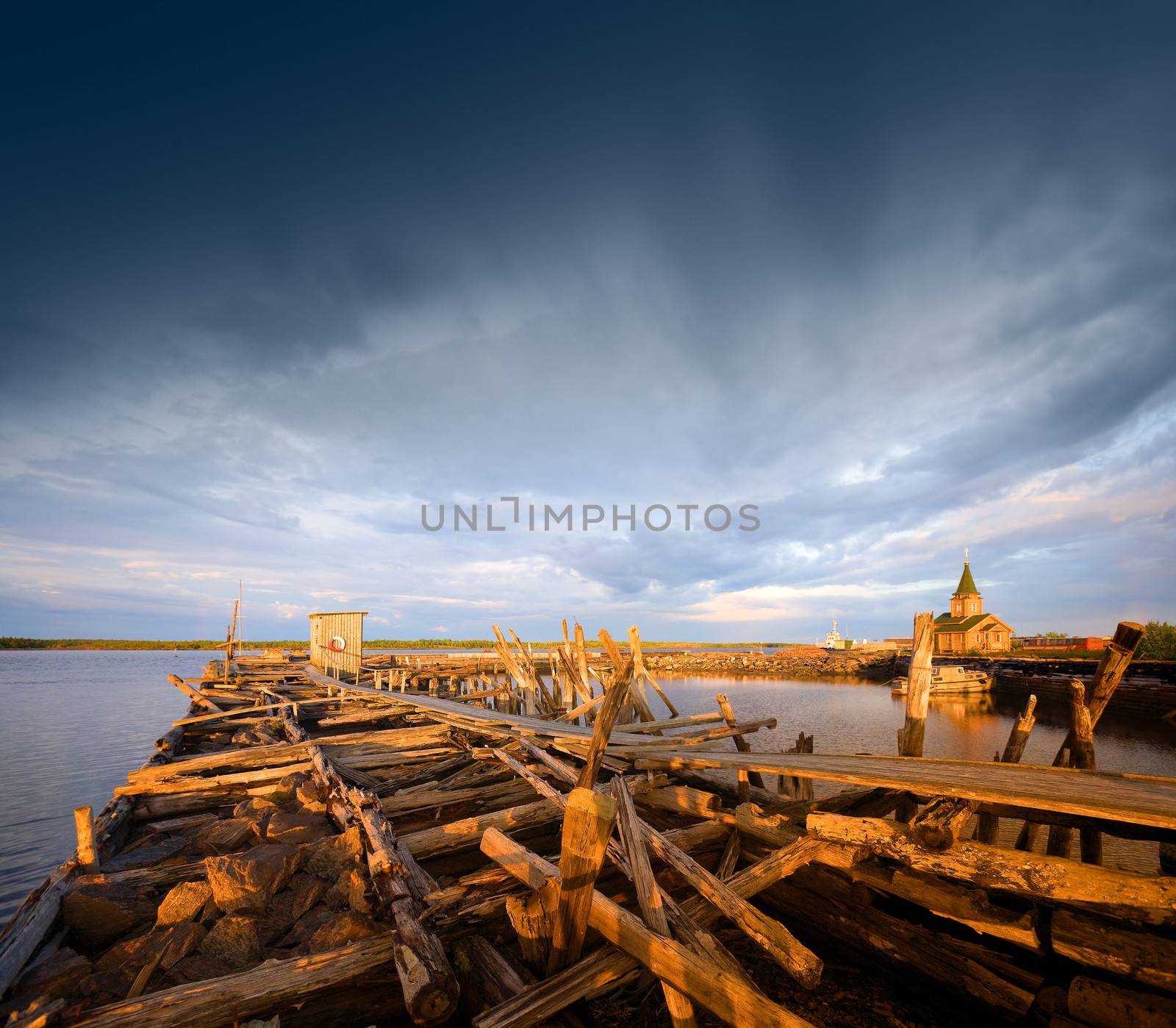 Old wooden pier at sunset.  White Sea, Karelia, Russia