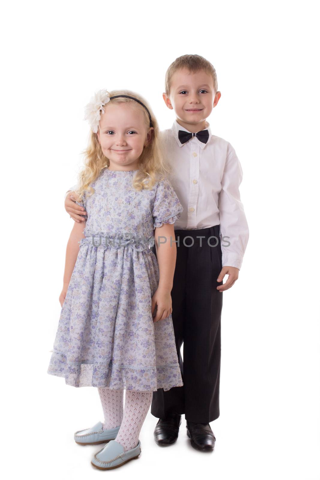 Smiling brother and sister standing together isolated on white