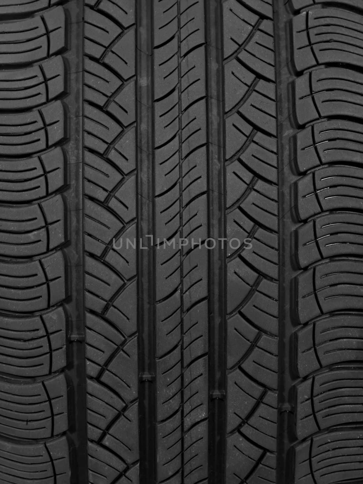 A black rubber tyre isolated against a white background