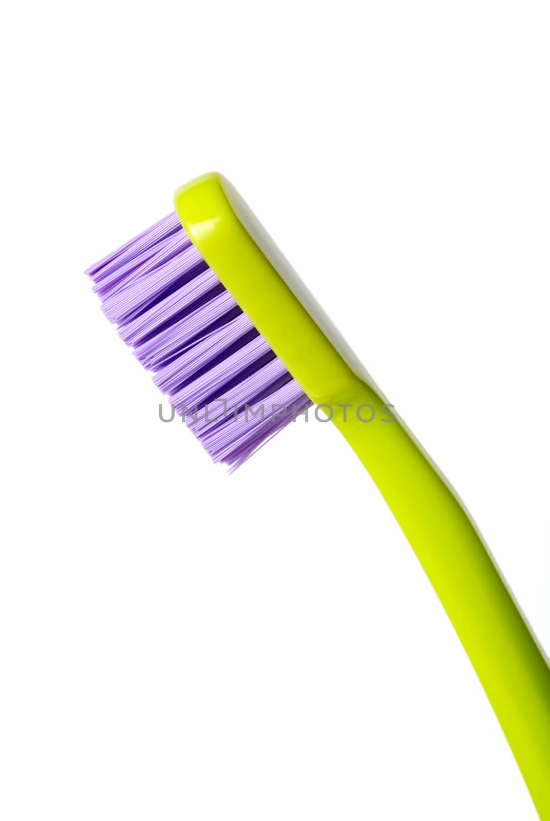 Colored toothbrush diagonally isolated on white background