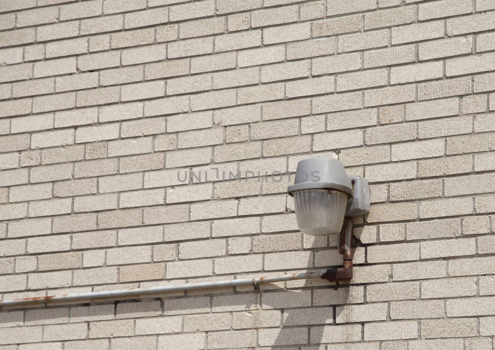Single light on a bare brick wall
