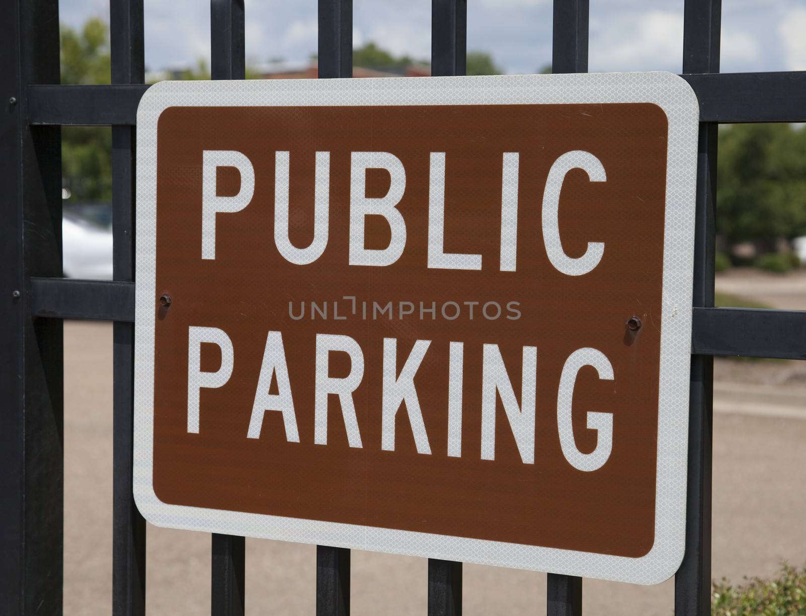 Brown public parking sign with white letters