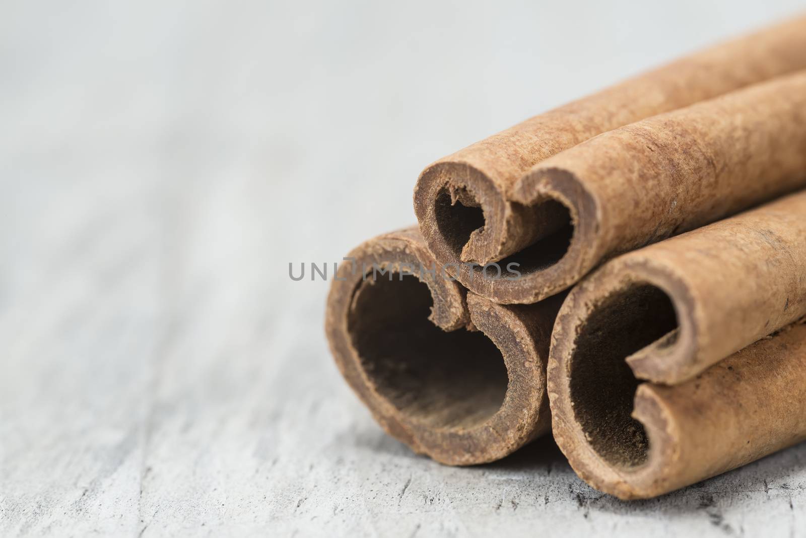 Cinnamon sticks on a wooden background by angelsimon