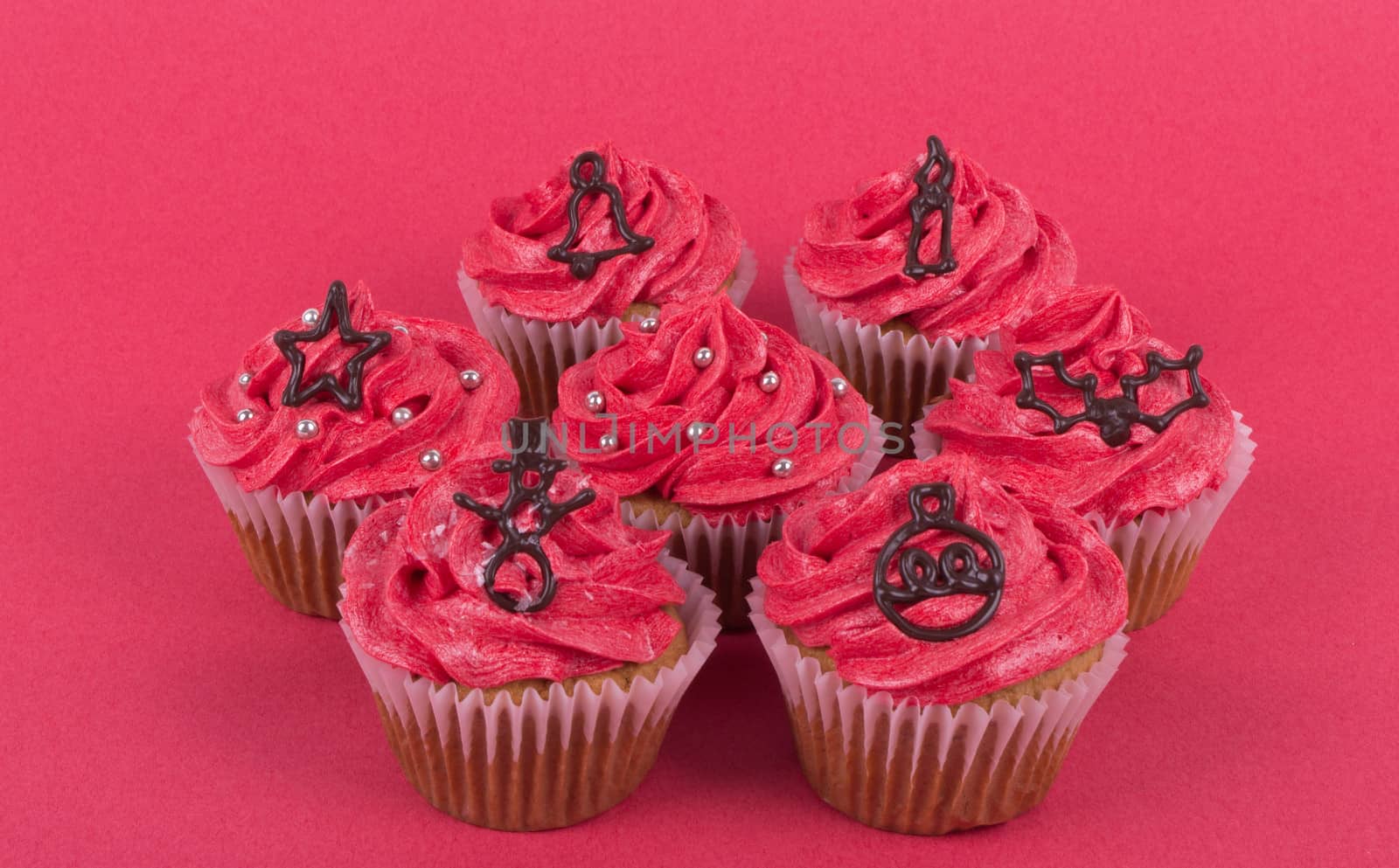 Group of Christmas cupcakes on red background