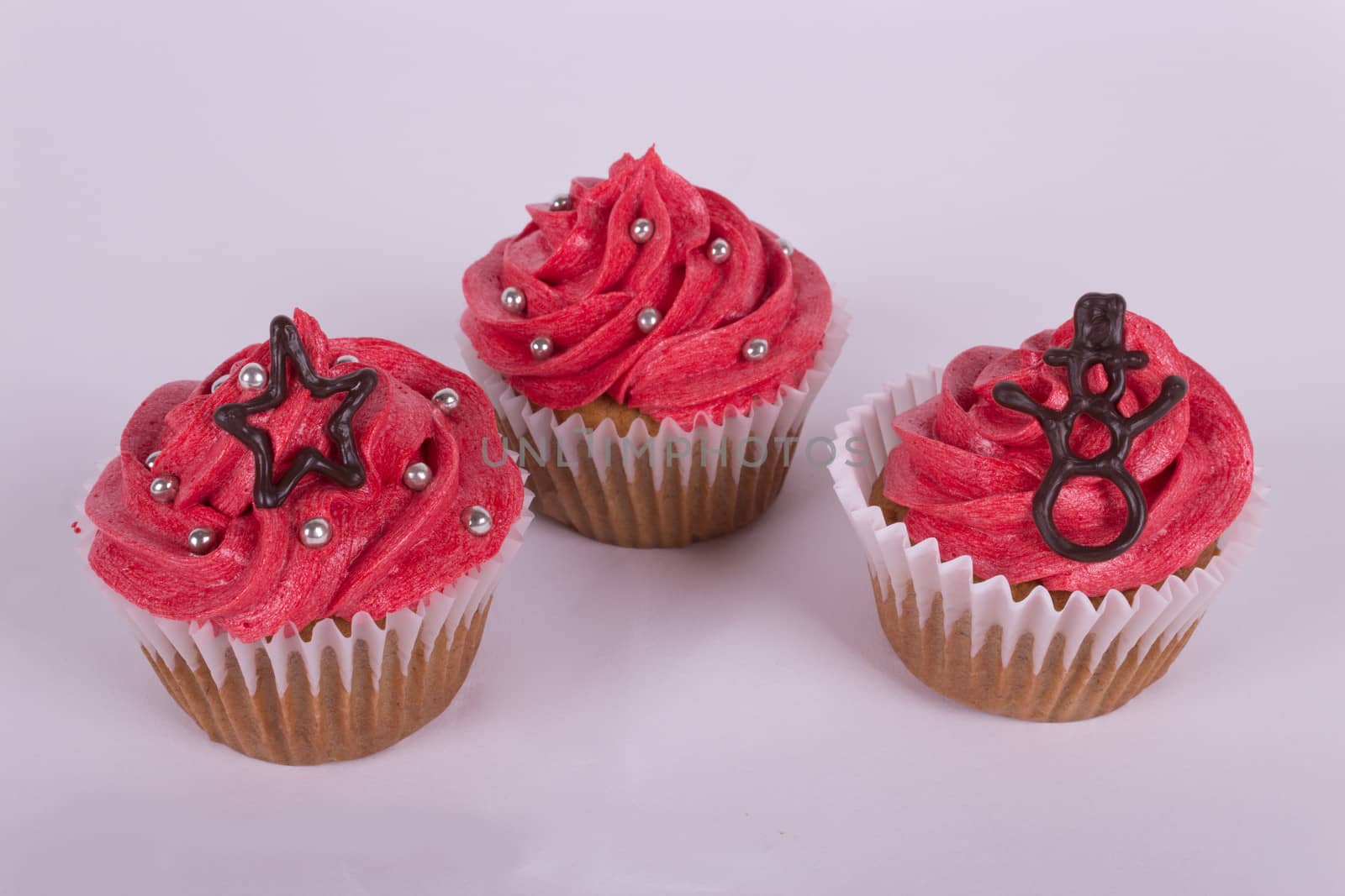 Group of Christmas cupcakes on white background