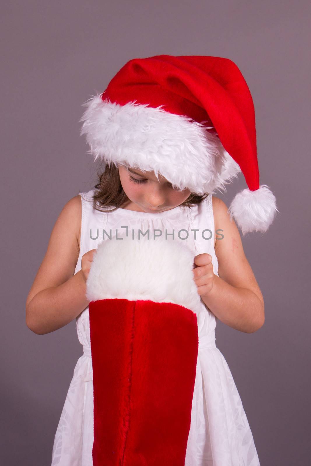 Little girl looking in her Christmas stocking