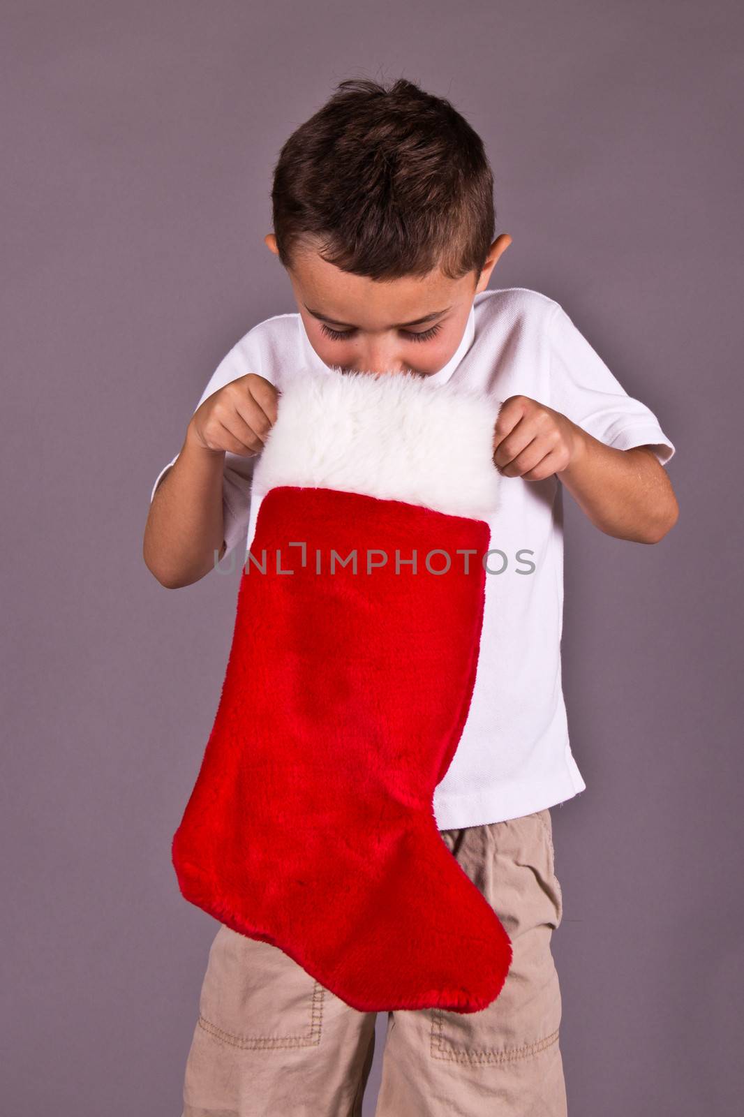 Little boy looking in his Christmas stocking