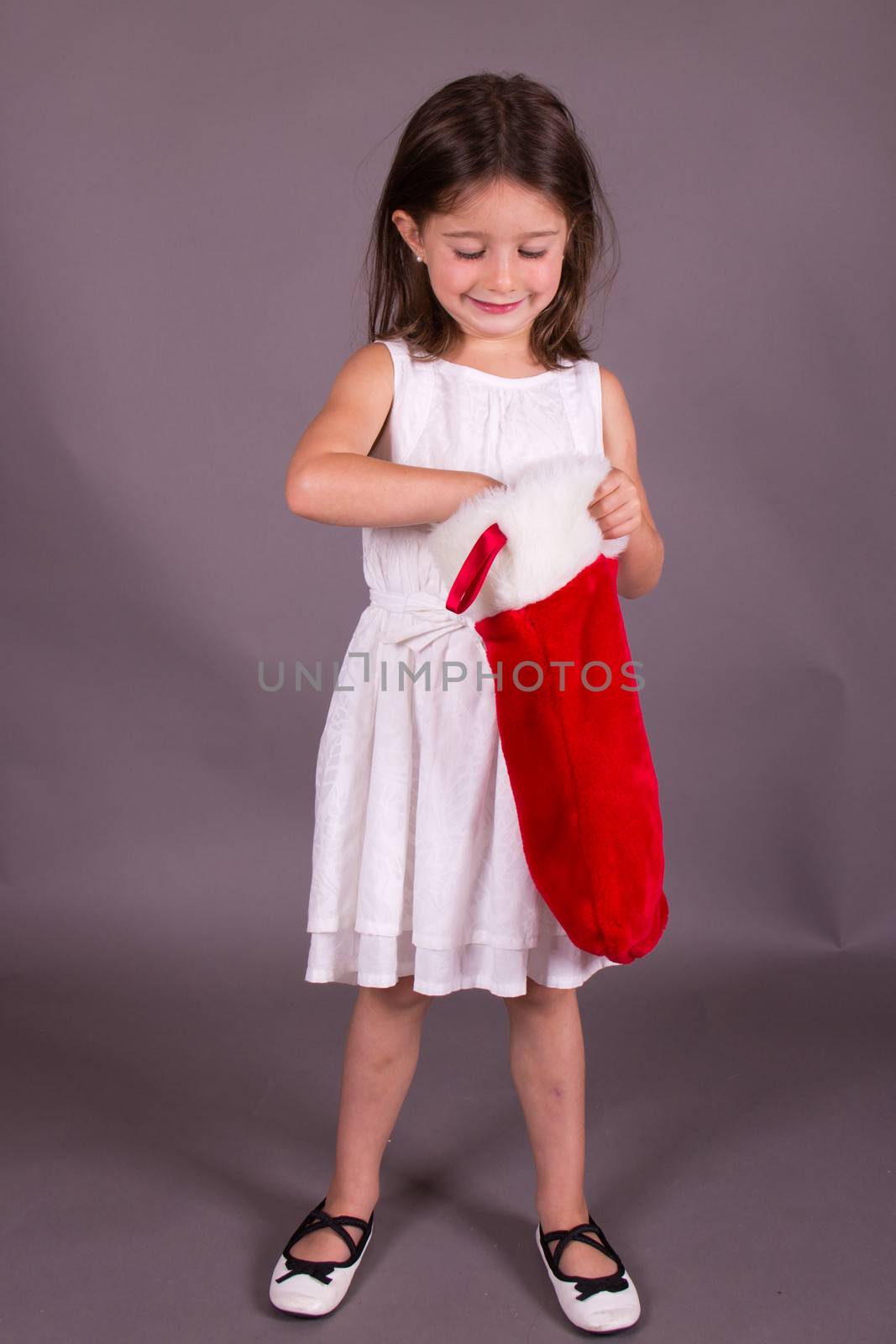 Little girl with Christmas stocking by bigjohn36