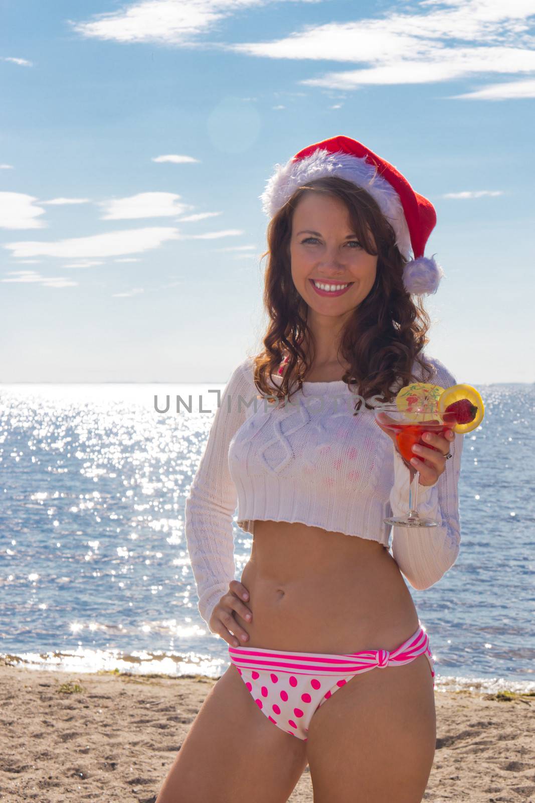 Girl with cocktail on the beach.  Christmas Vacation